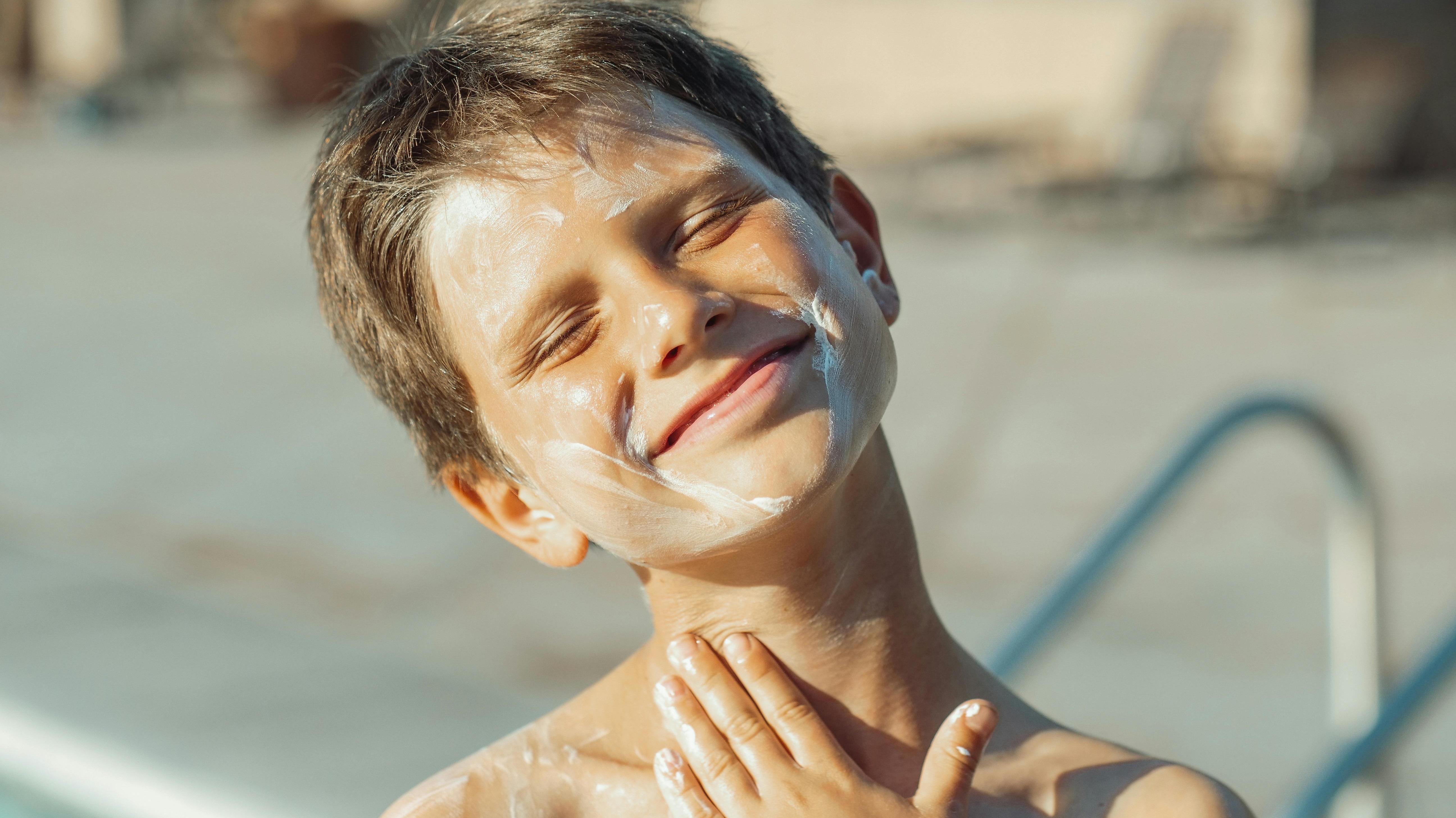 Family enjoying sunny pool day, perfect for non-toxic baby sunscreen.