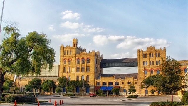 Colorful 'Crazy Hispanic Fan' caps held in hand, vibrant design.