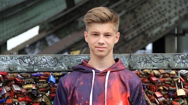 Teenage boy expressing forgetfulness reasons outdoors.