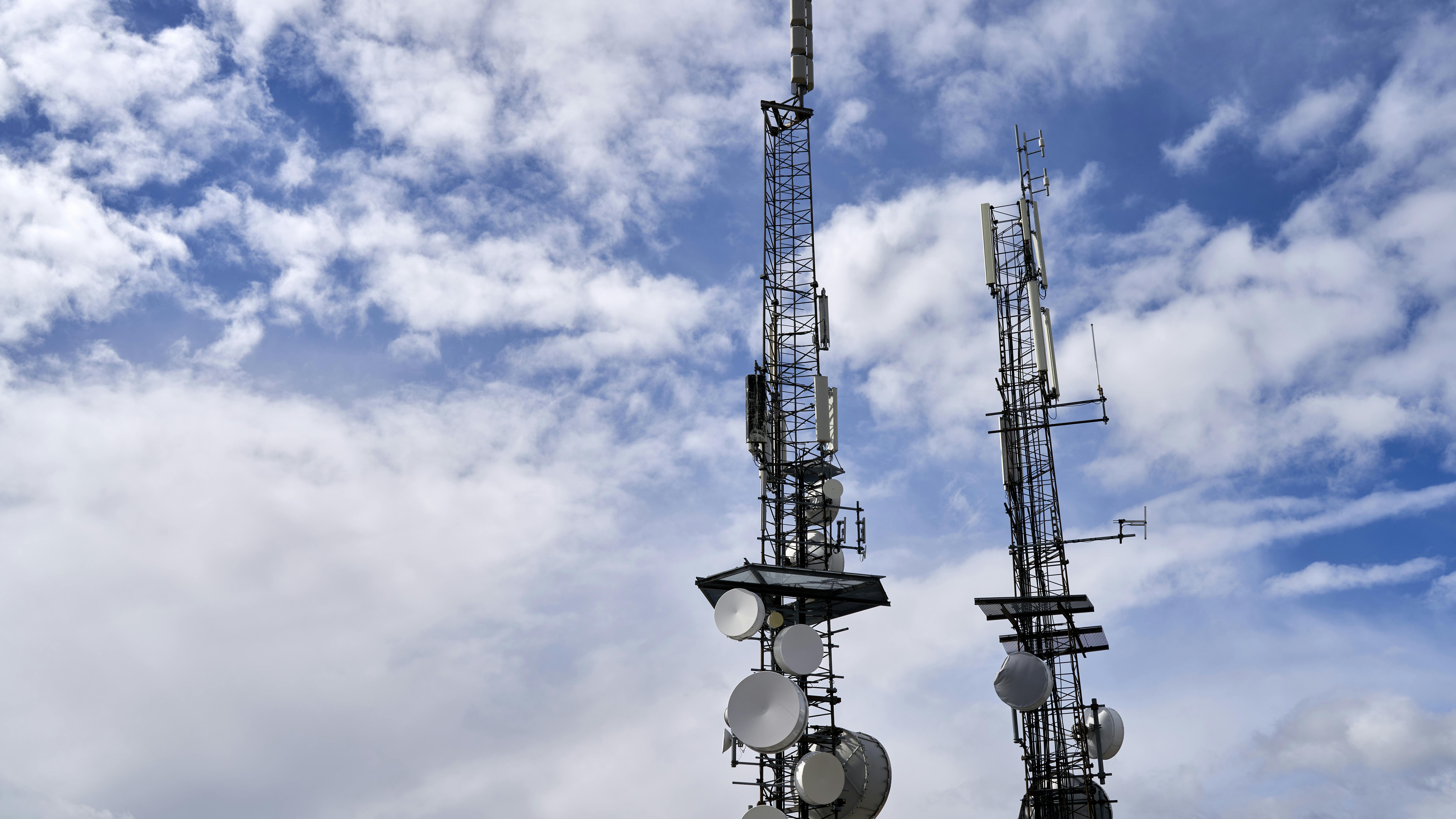 Alabama broadband expansion updates: Fiber optic cables being installed in rural area with excavator.