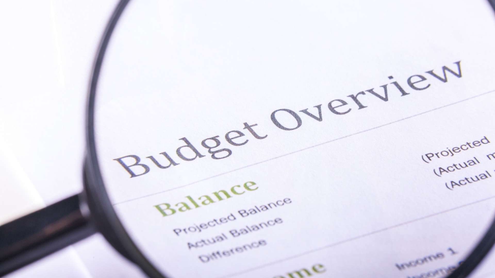 Confident man on terrace, symbolizing AI budgeting strategies, city view.