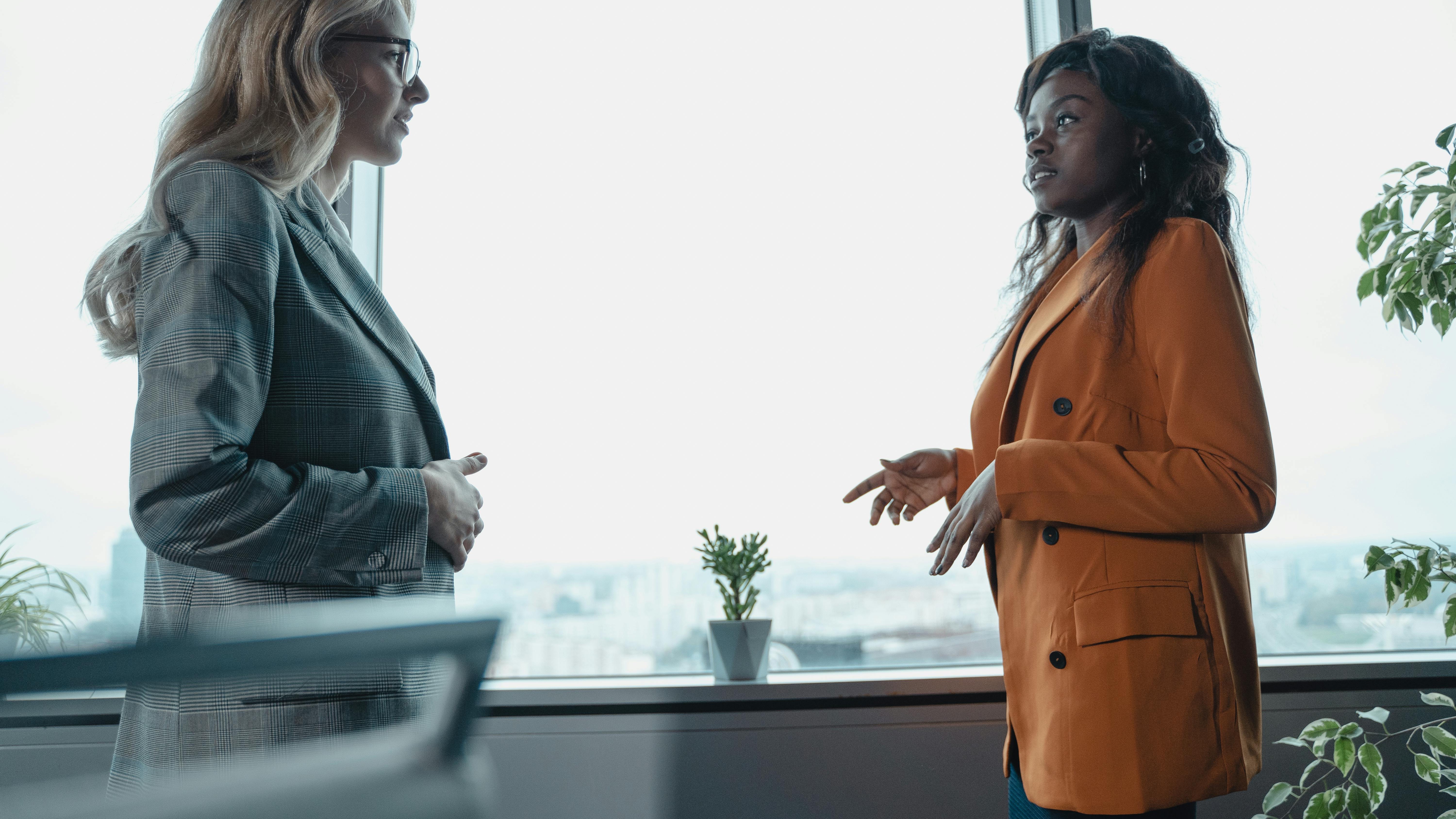 Business professionals reviewing documents, reverse recruiting meeting.