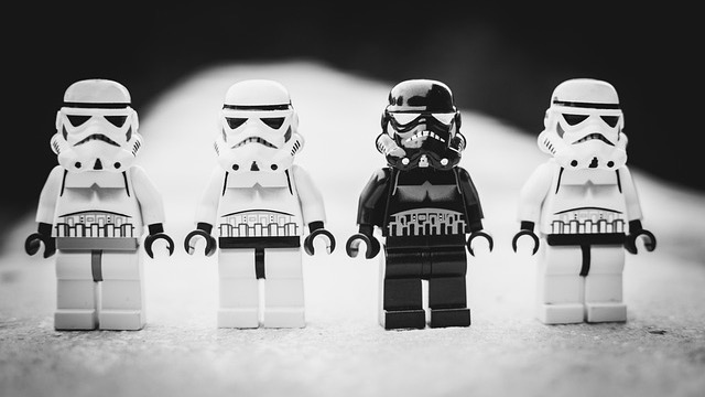 Close-up of intense eyes with water droplets in cinematic lighting.