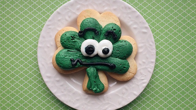 Young girl celebrating St. Patrick’s Day in a kitchen.