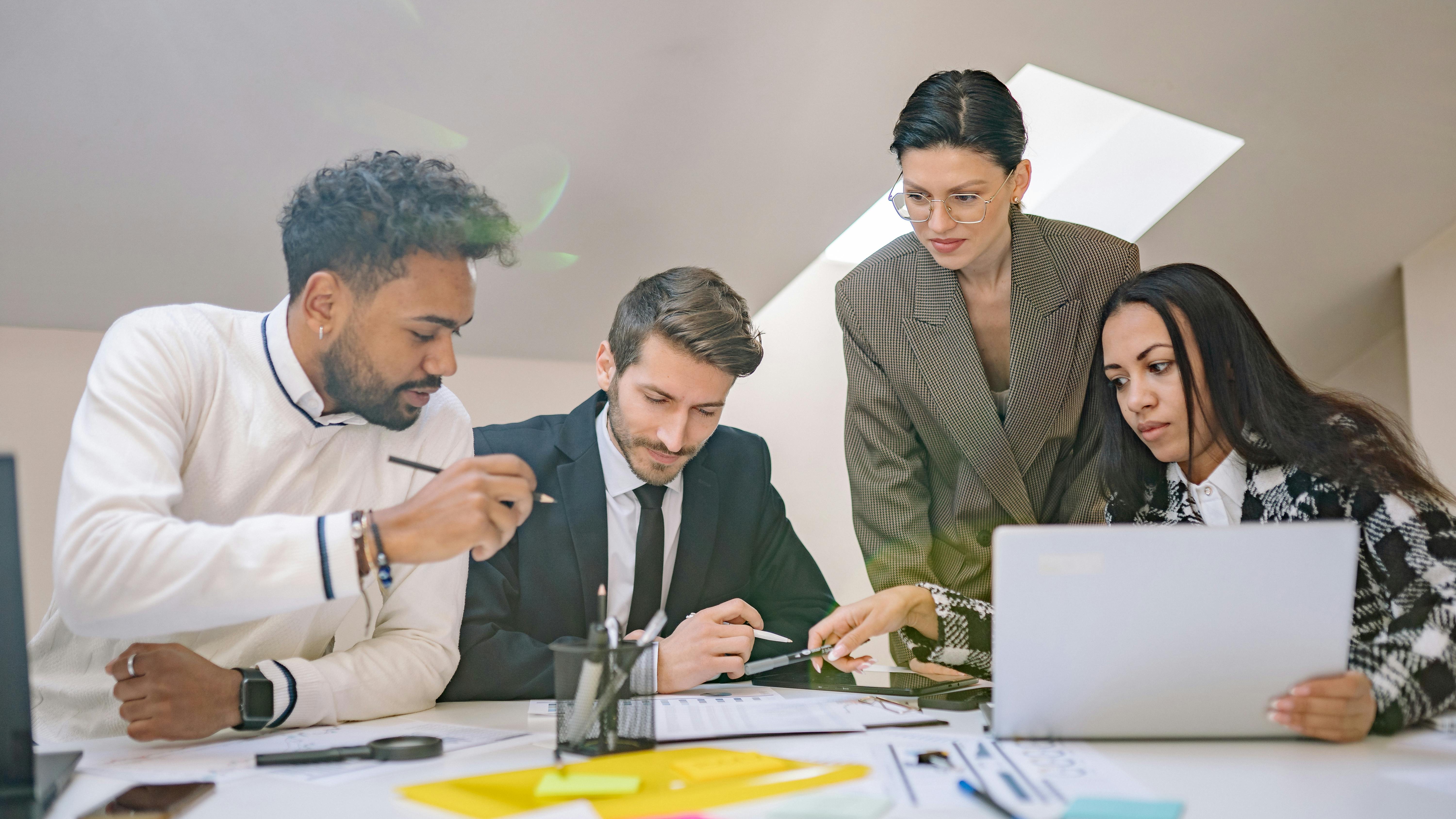 Man explaining data on a screen, embedding AI into daily workflows.
