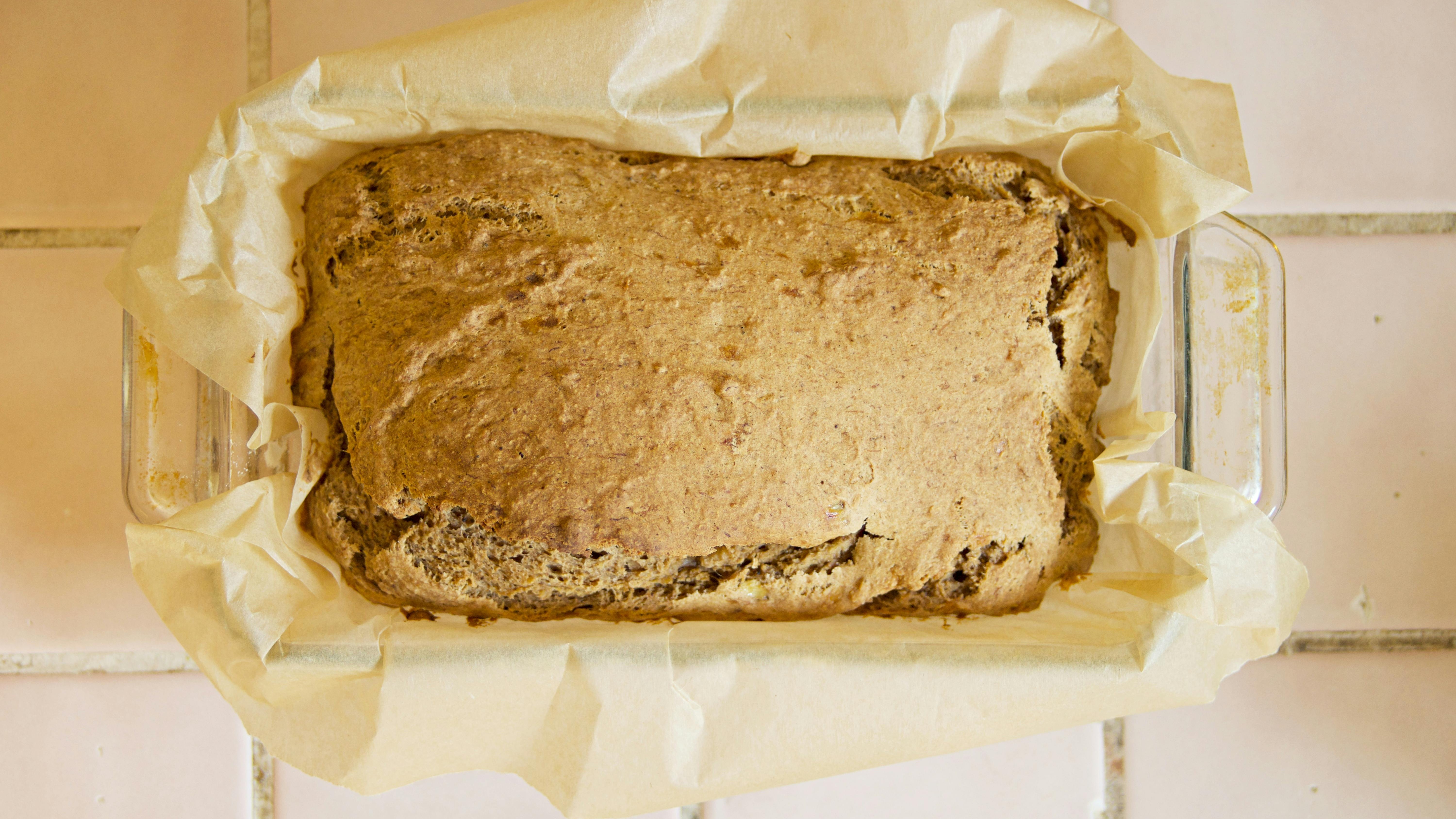 Oatmeal banana bread recipe with fresh berries on pink plate.