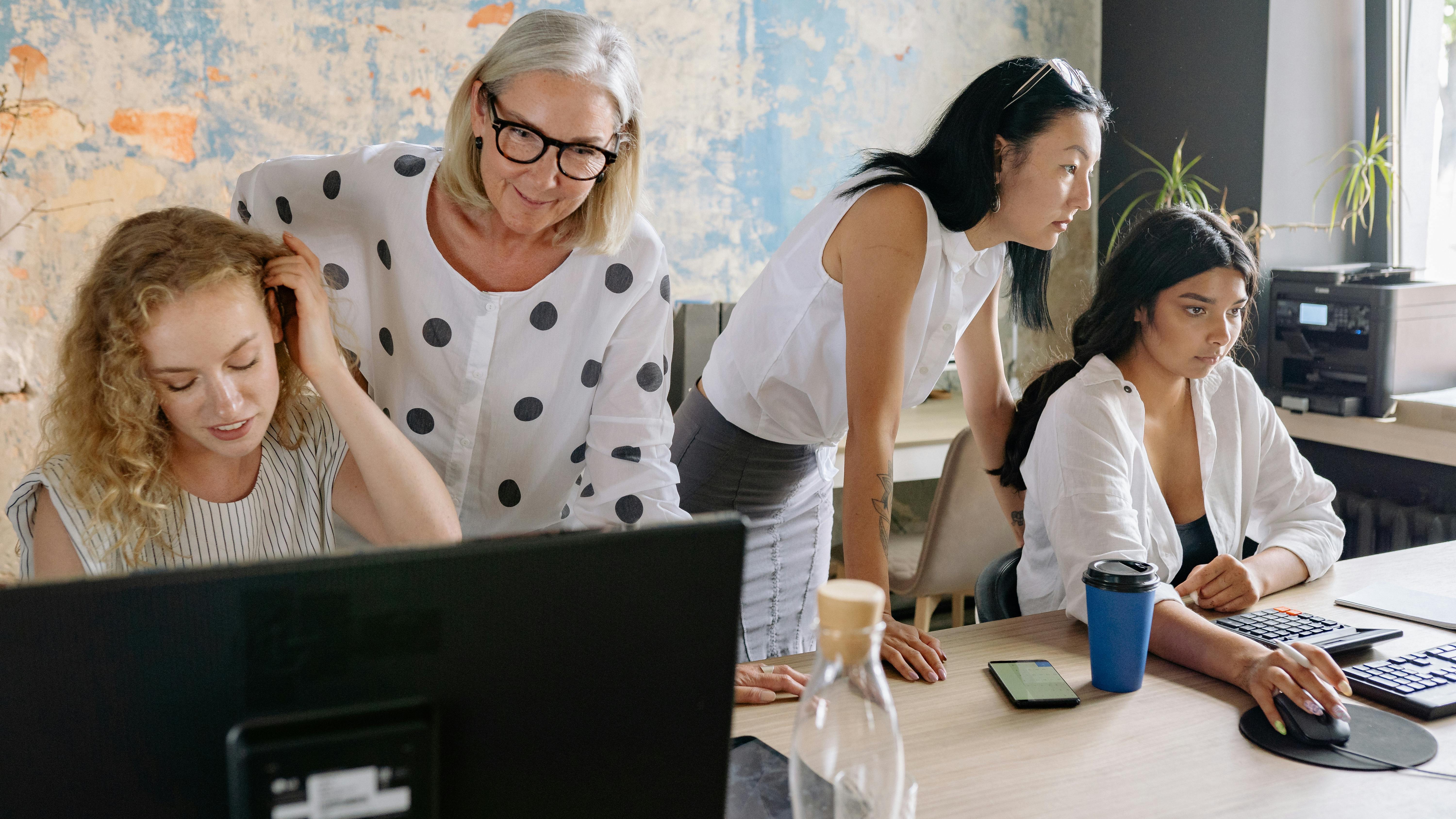 Diverse young adults taking selfie, showcasing workplace culture retention.