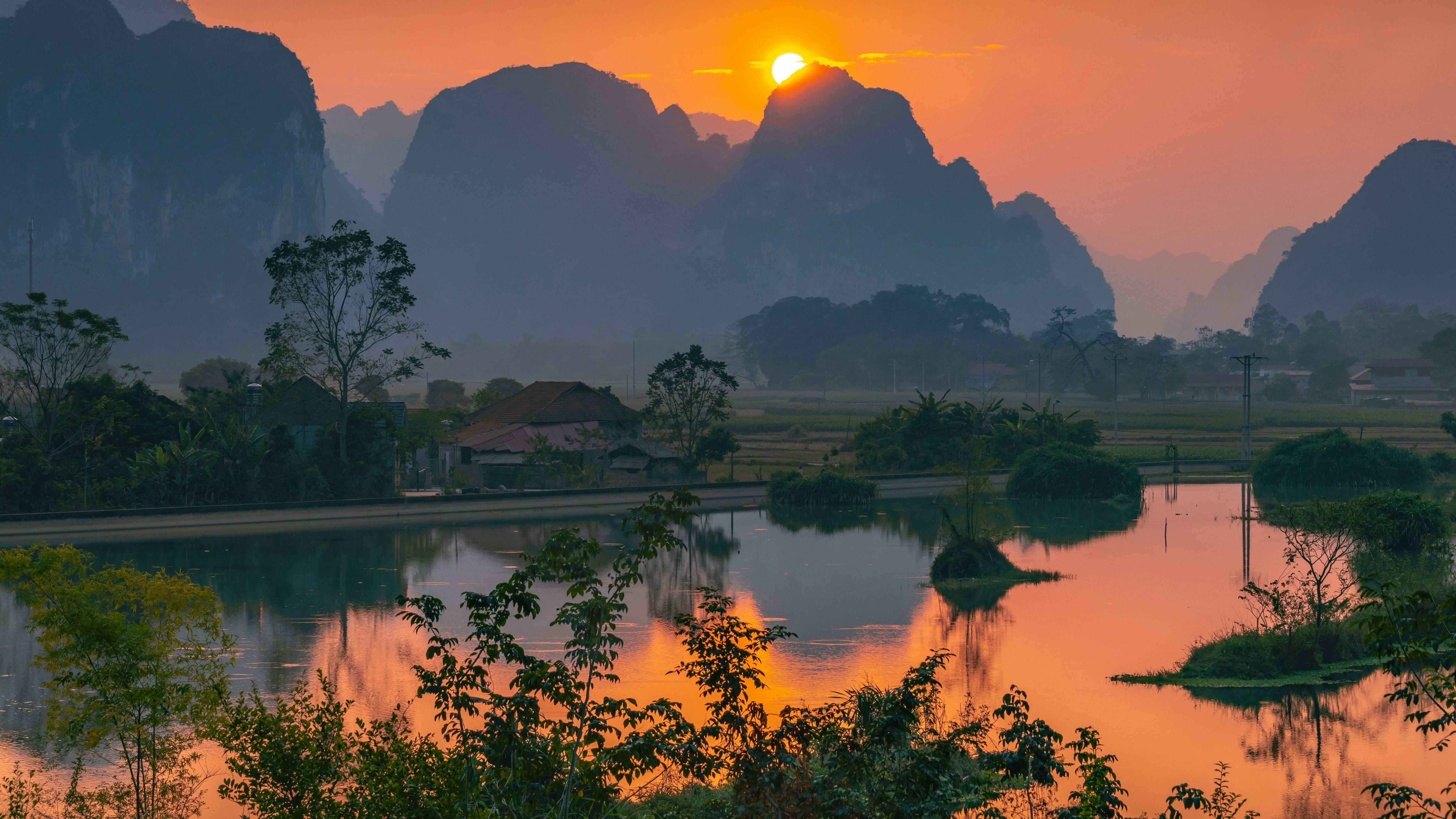 Wounded soldiers assist each other on battlefield, North Vietnam tank battle.