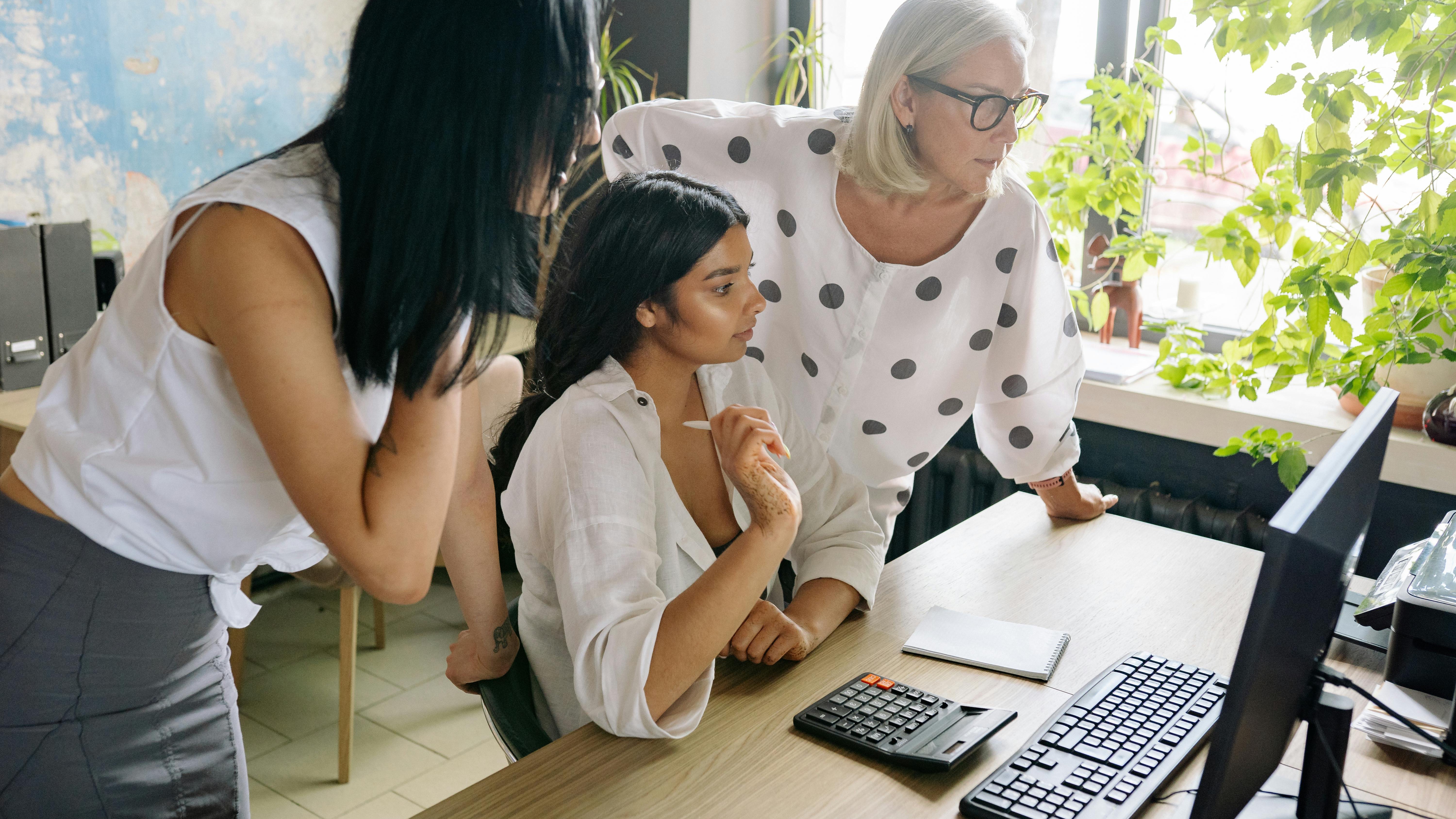 Women in business Omaha, confident professional smiling in front of geometric background.