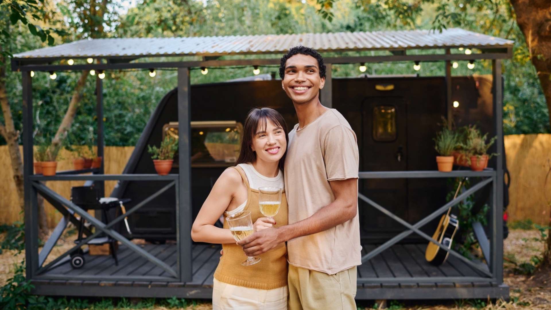 Couple in a cozy tiny home sharing a book, modern interior design.