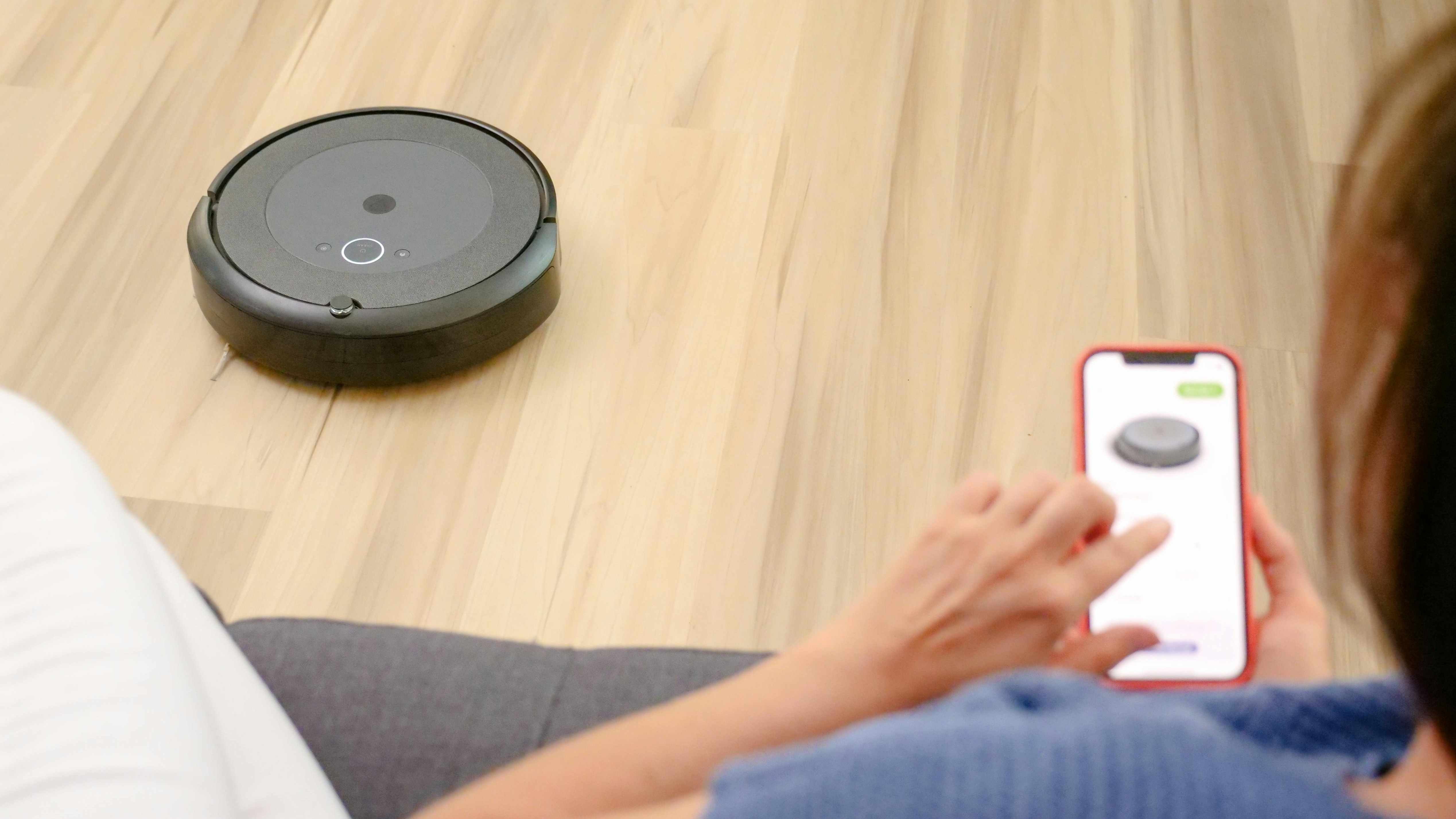 Sleek hybrid robot vacuums that mop on tiled kitchen floor, sunlight reflections.