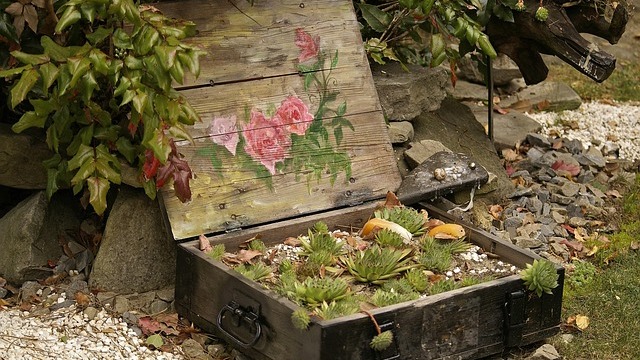 Tranquil small garden with blooming flowers and fountain centerpiece.