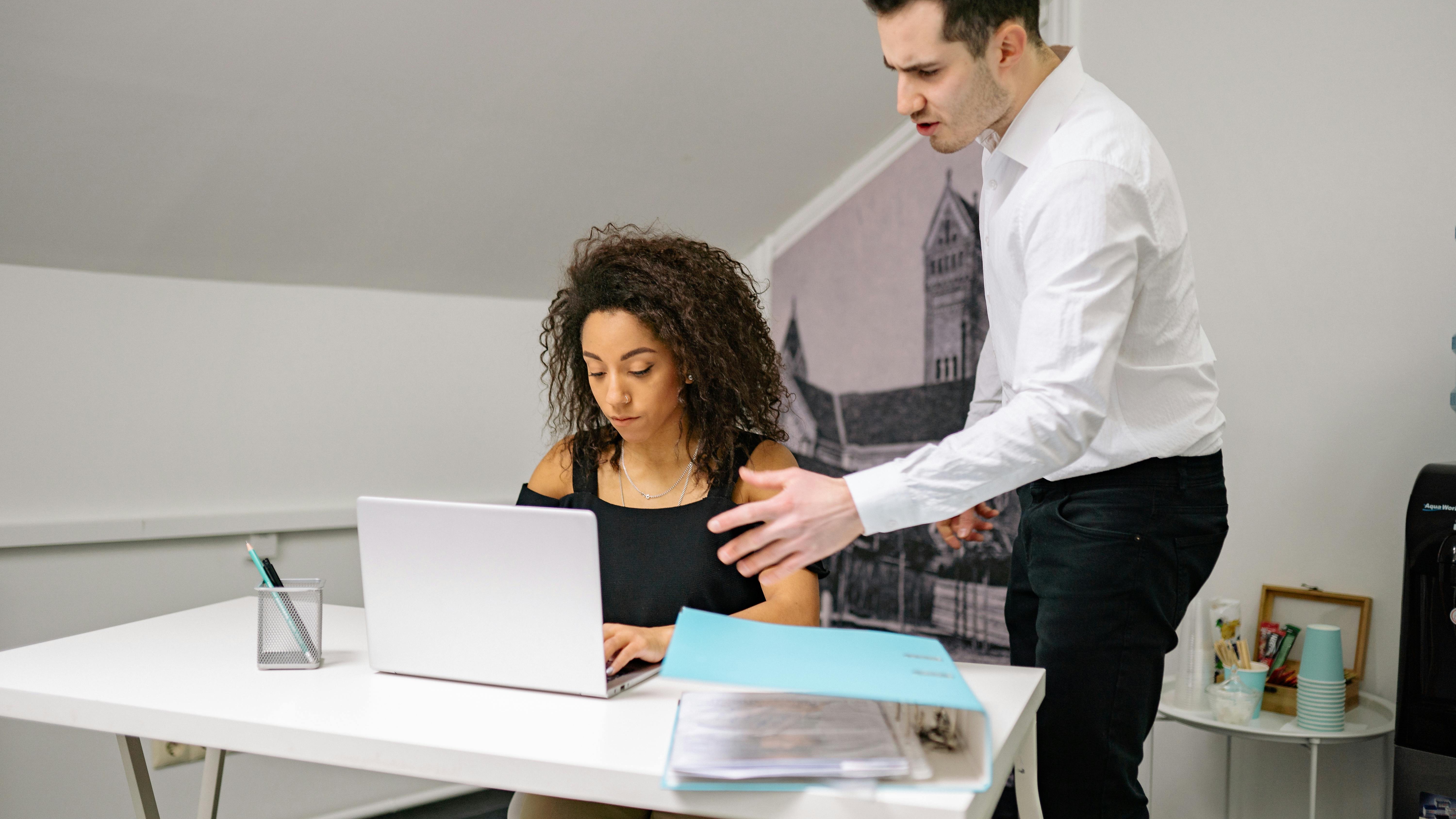 AI transforming early-career jobs: Two professionals collaborating in a modern office.