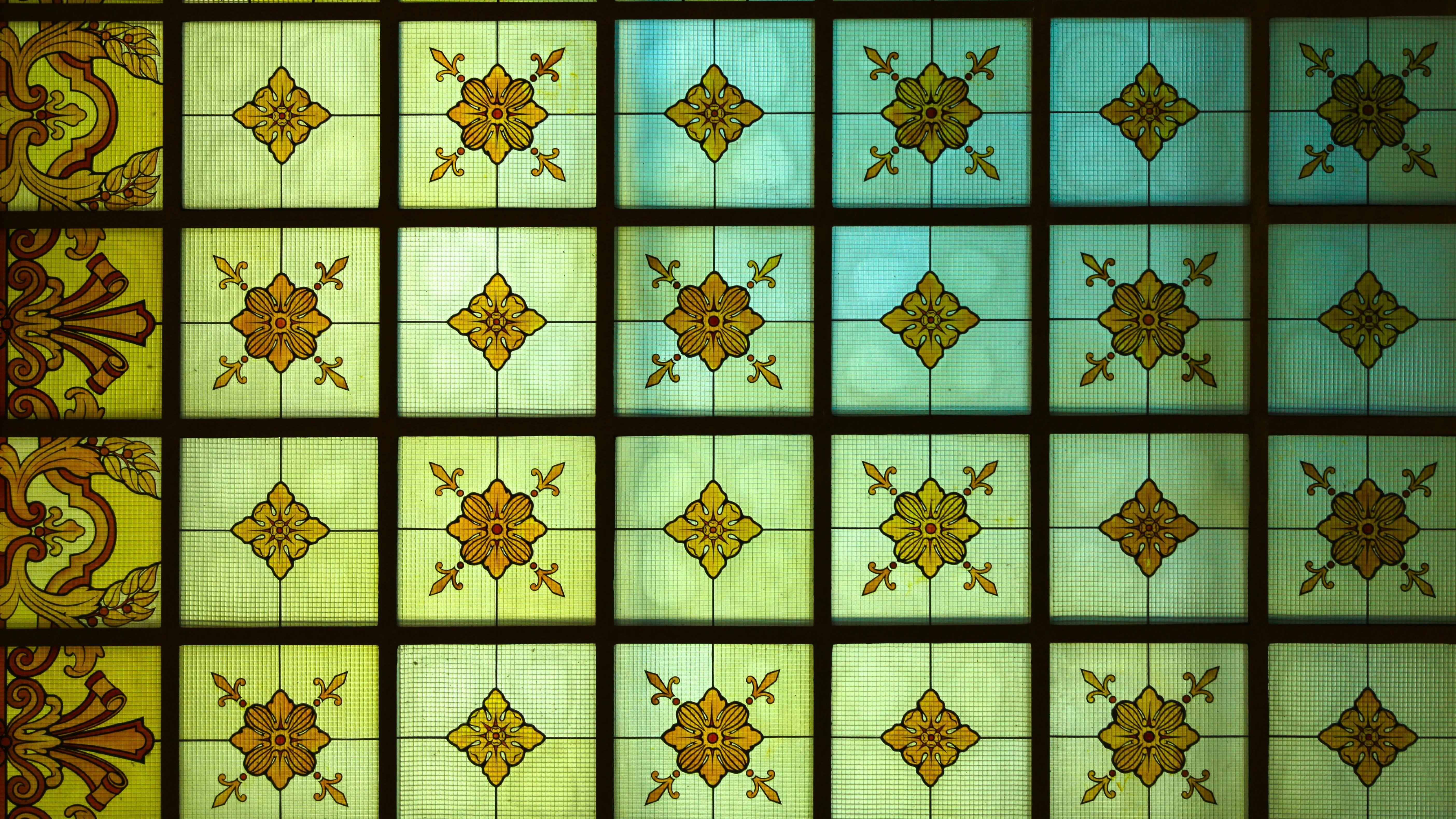 Vintage stained glass with floral patterns, rich colors, intricate details