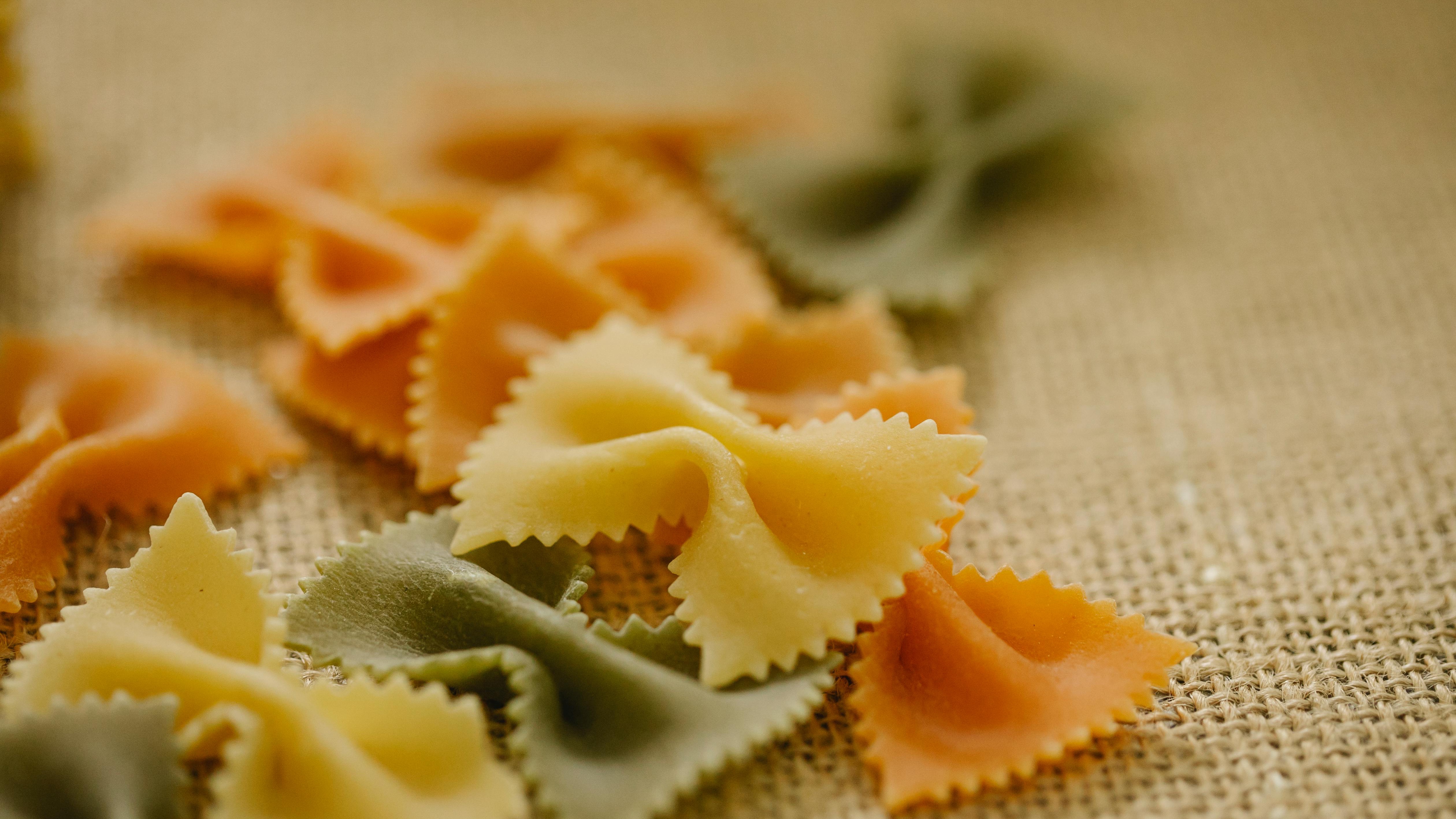 Easy bowtie pasta butterfly craft with colorful designs on paper