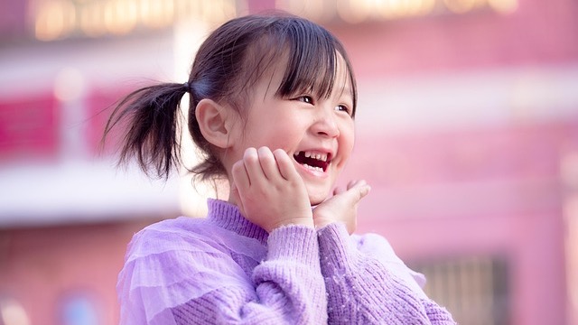 Tips to avoid after school meltdowns from smiling woman indoors.