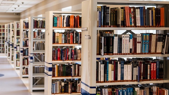 Interior of Omaha $158 million library with attendees and elegant lighting.