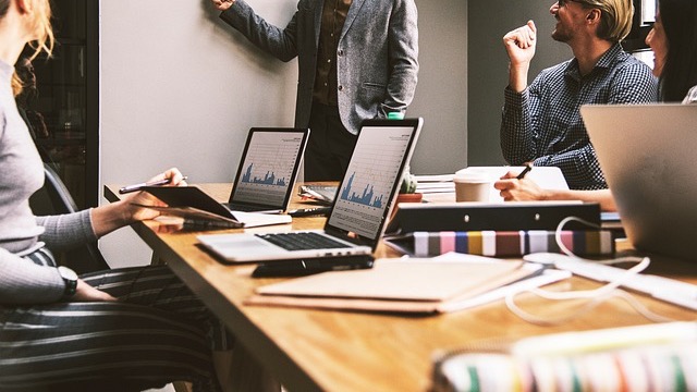 Middle-aged man holding documents, illustrating career security skills.