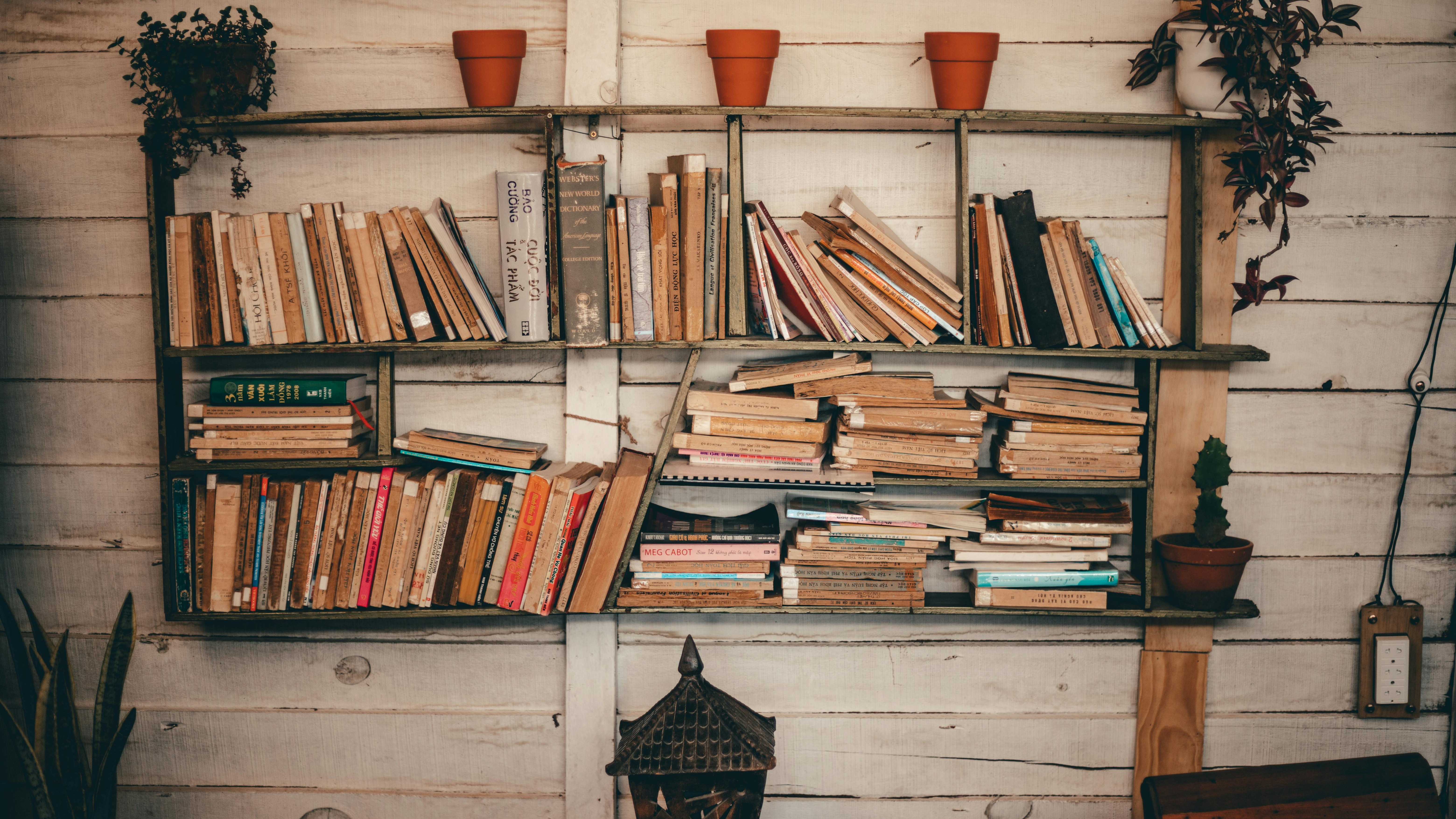 Antique brass labels for fiction, horror, poetry in a small home office.