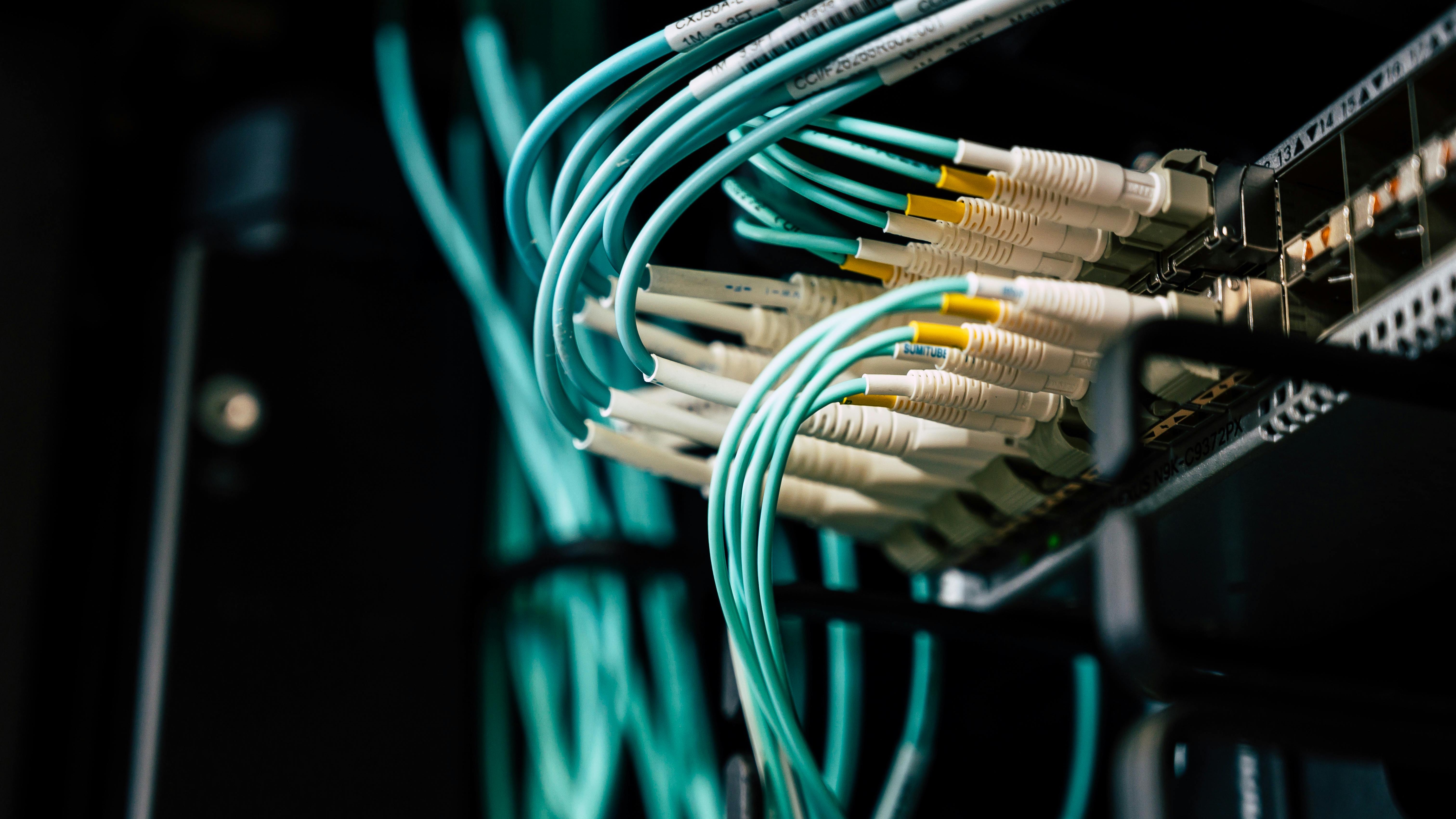 Businessman smiling against yellow backdrop with company logo.