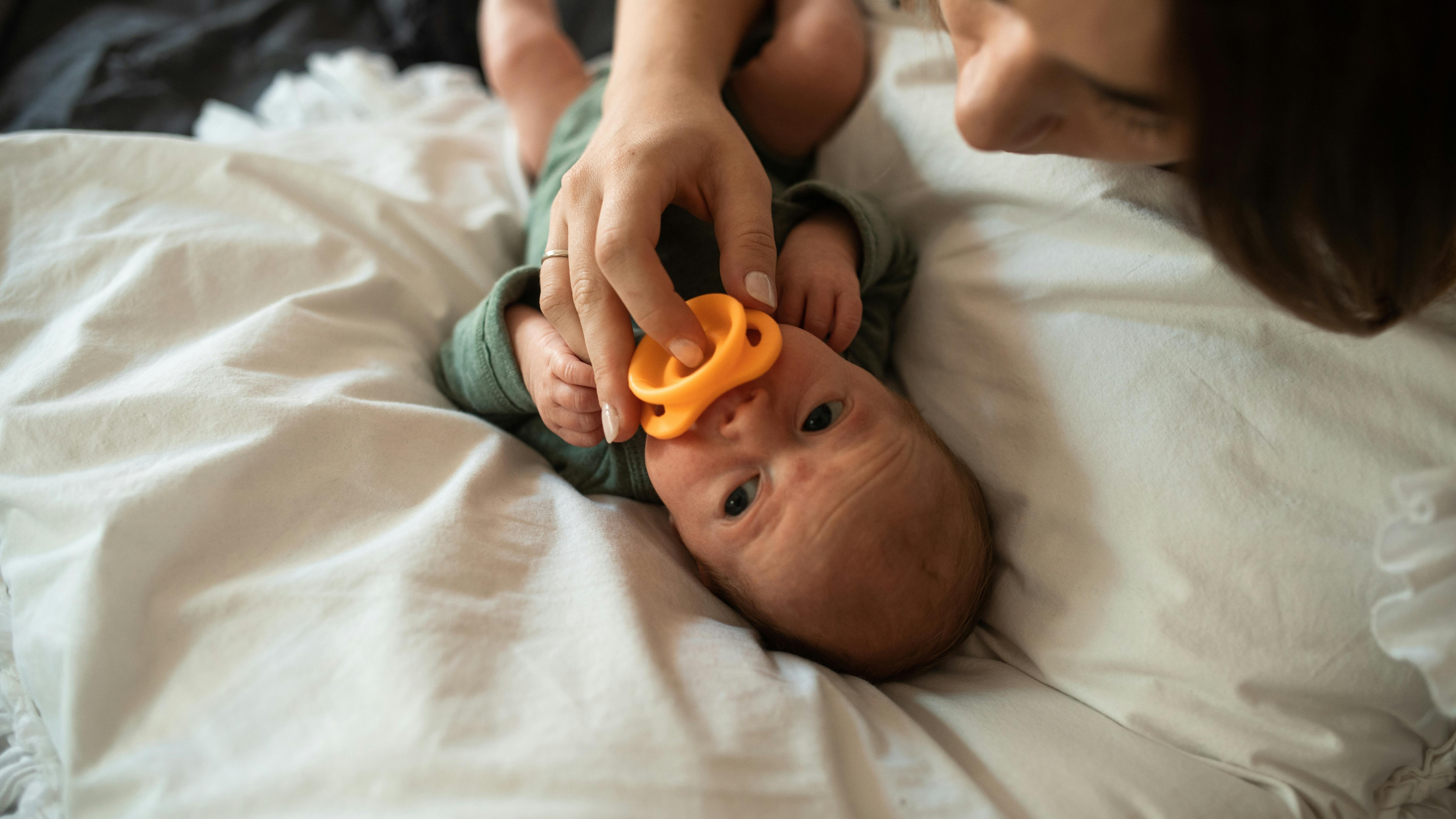 Mother cuddling newborn, ideal postpartum recovery setting.