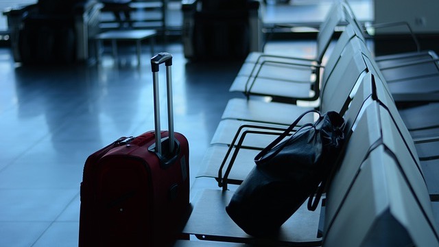 JetBlue airplane moving on runway highlights checked bag fees increase.