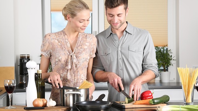 Smiling couple runs a farm business together on a porch with lush scenery.