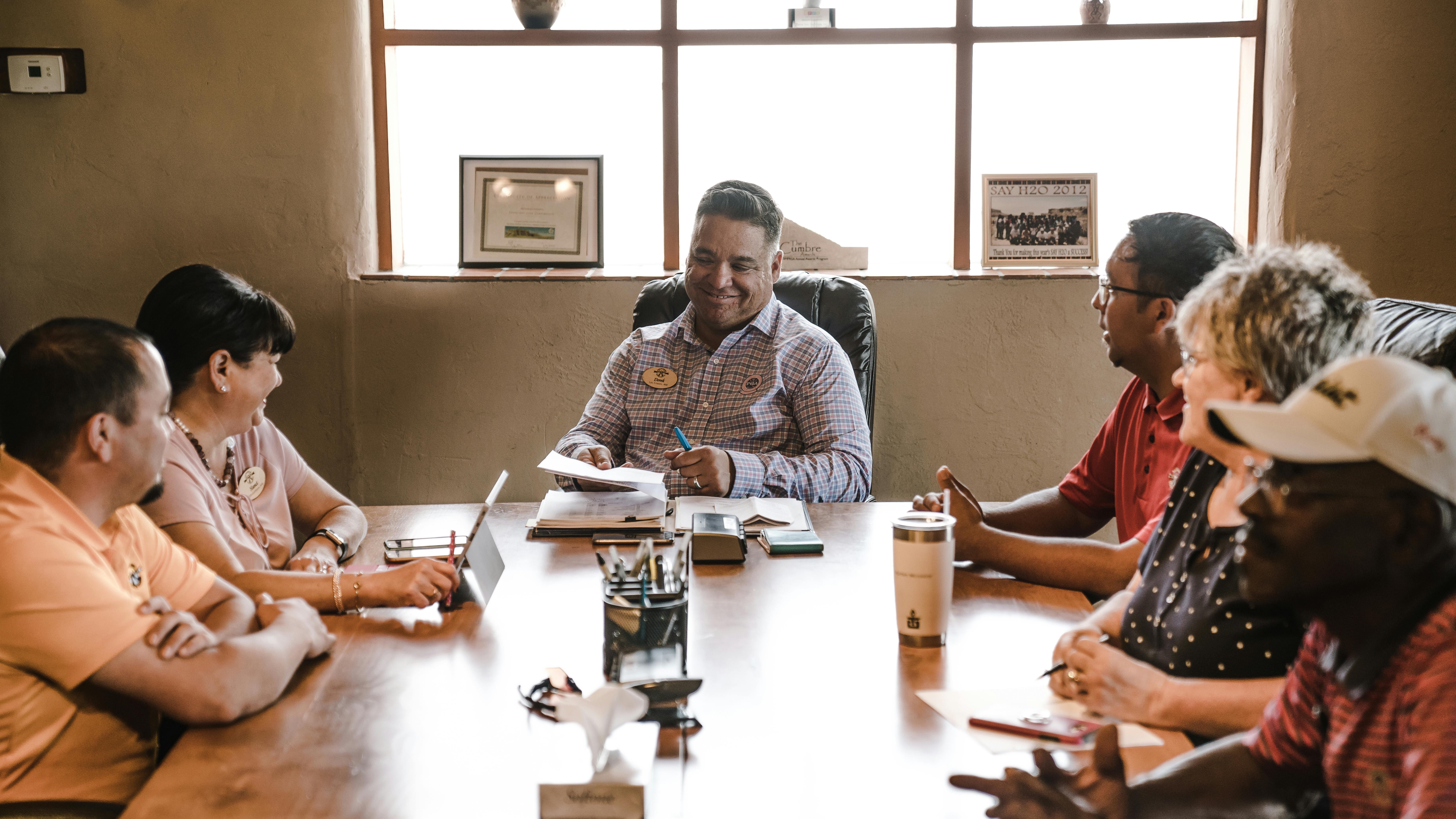 Diverse industrial workers smiling, showcasing value of diversity in the workplace.