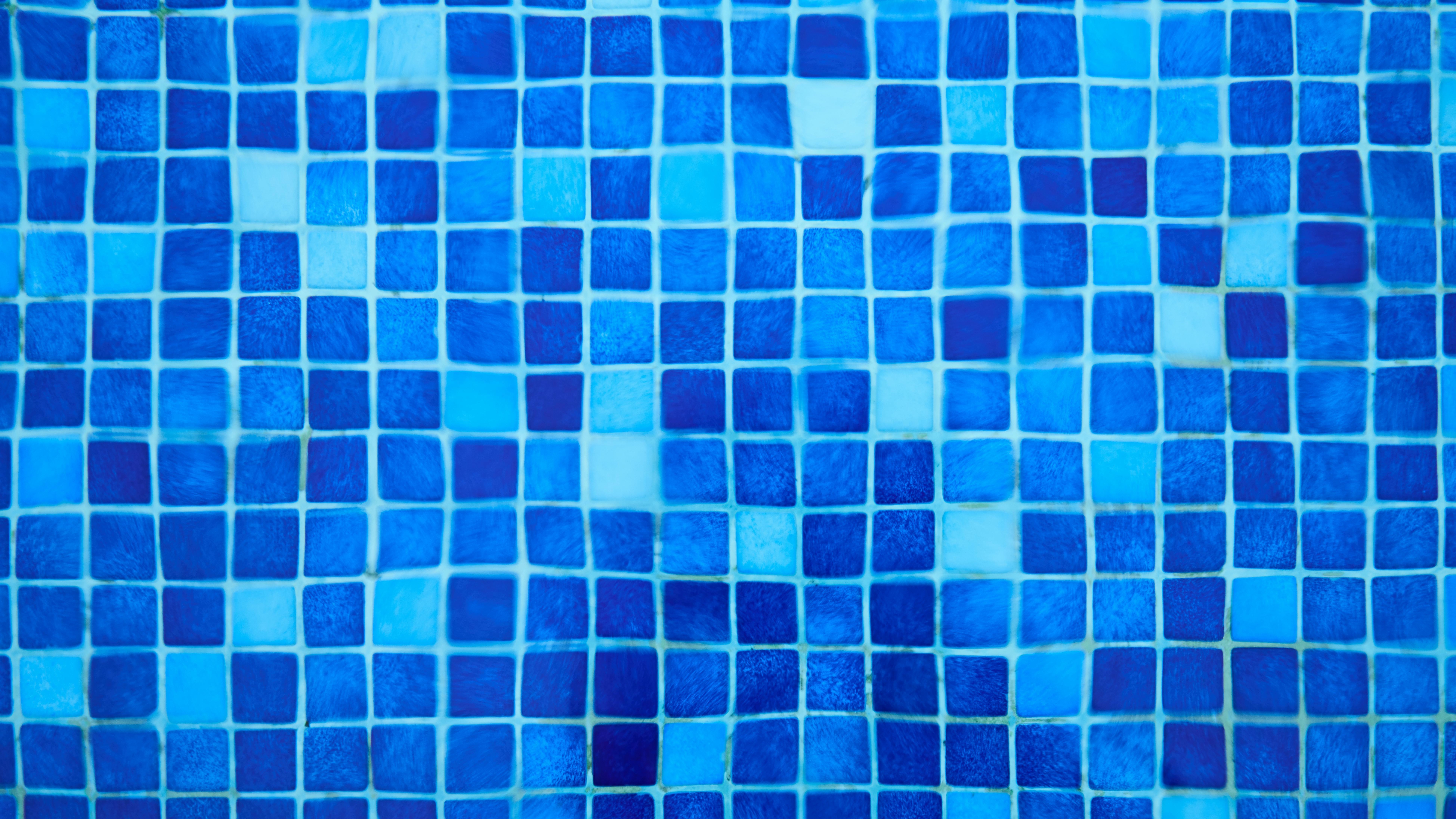 Modern kitchen with dark floor tiles and elegant design.