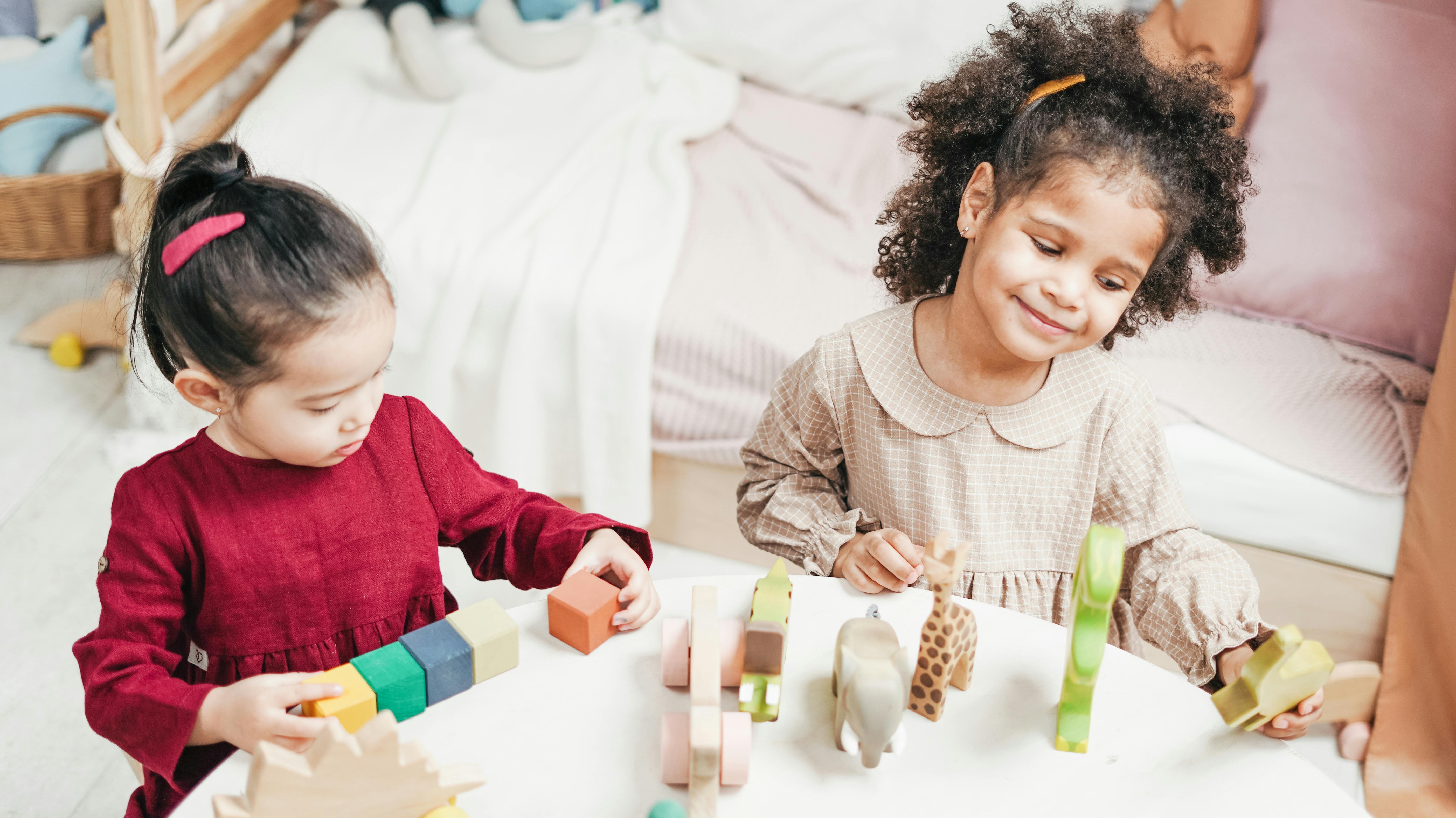 Children playing with child development toys under table