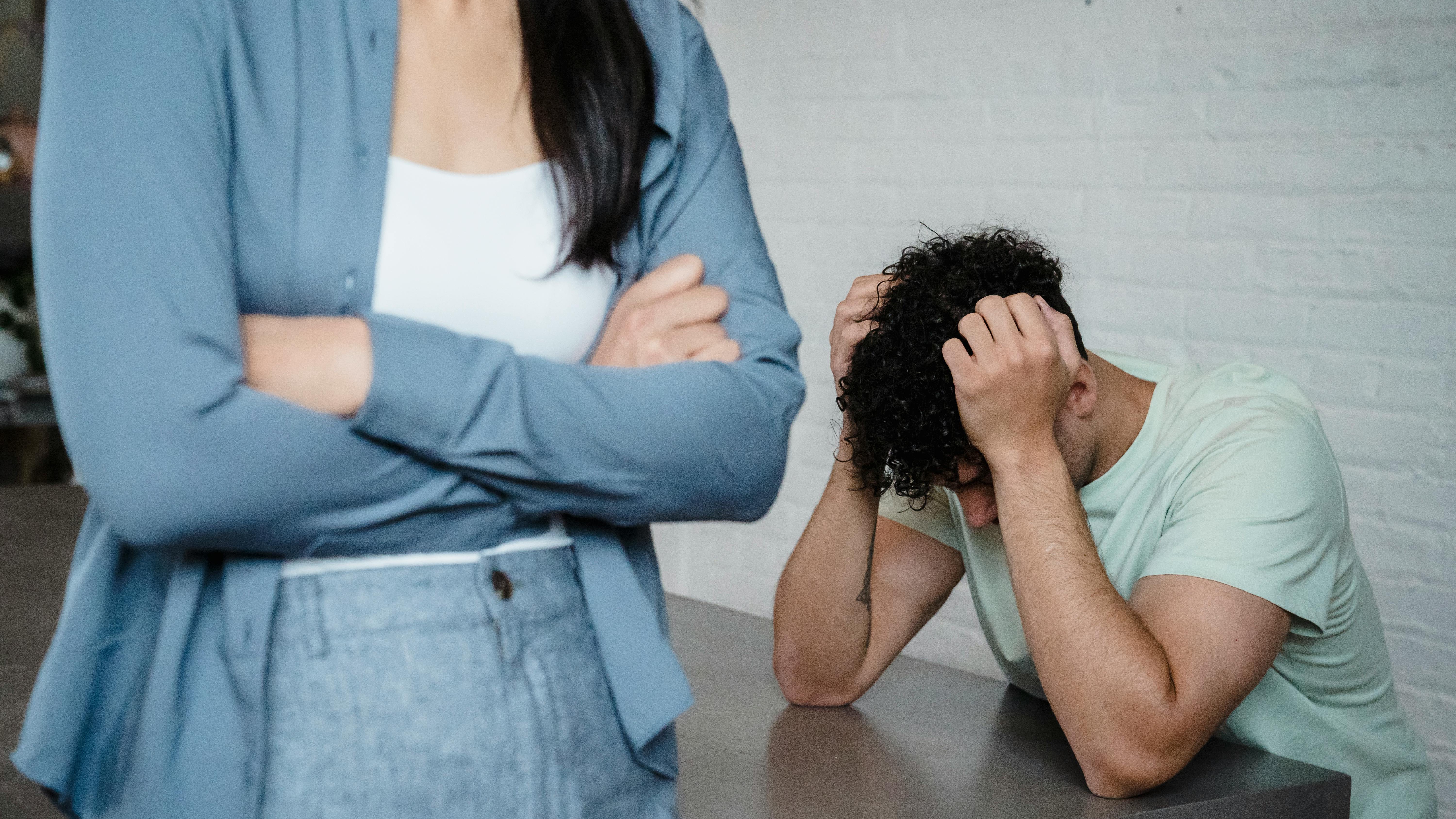 Smiling couple hiking in forest, reflecting government shutdown impact on household finances.