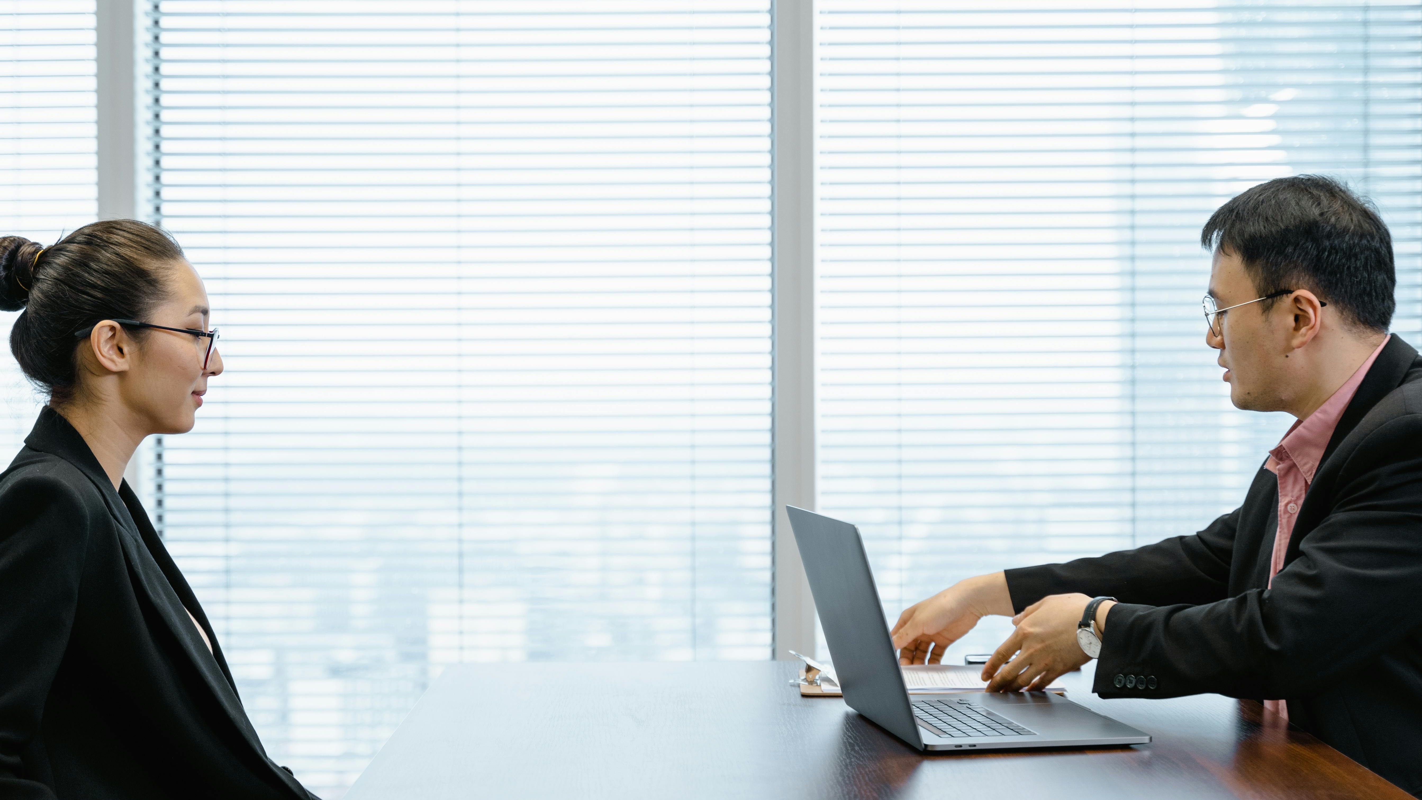 Robotic hand with magnifying glass examining candidate experience metrics.