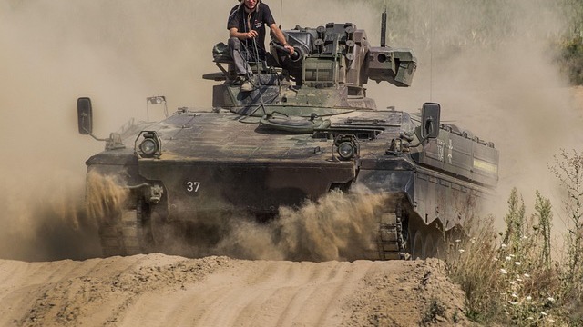 Military vehicle in rural setting illustrates military jobs.