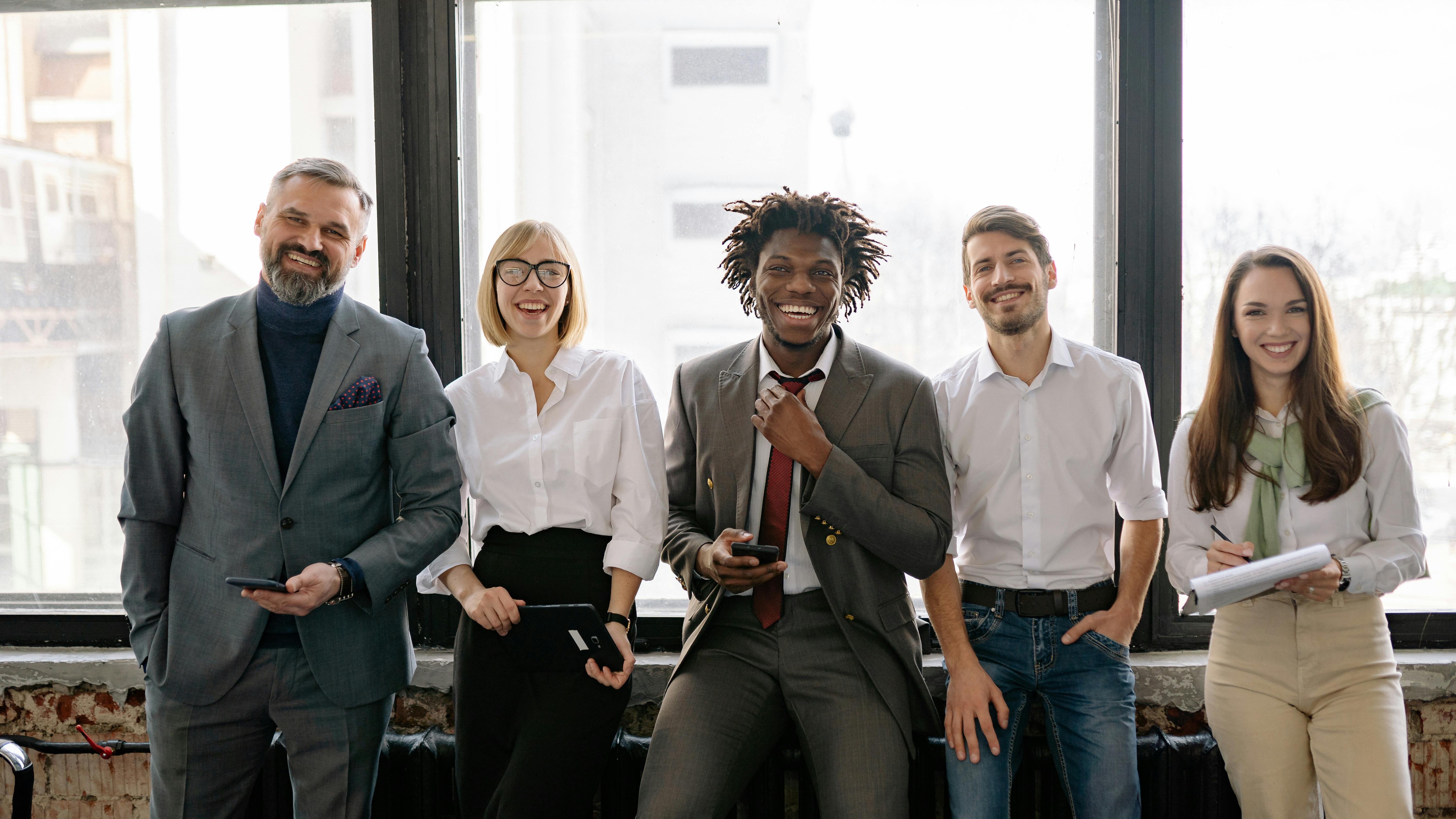 Minimalistic symbols representing diversity and inclusion against a gray backdrop.
