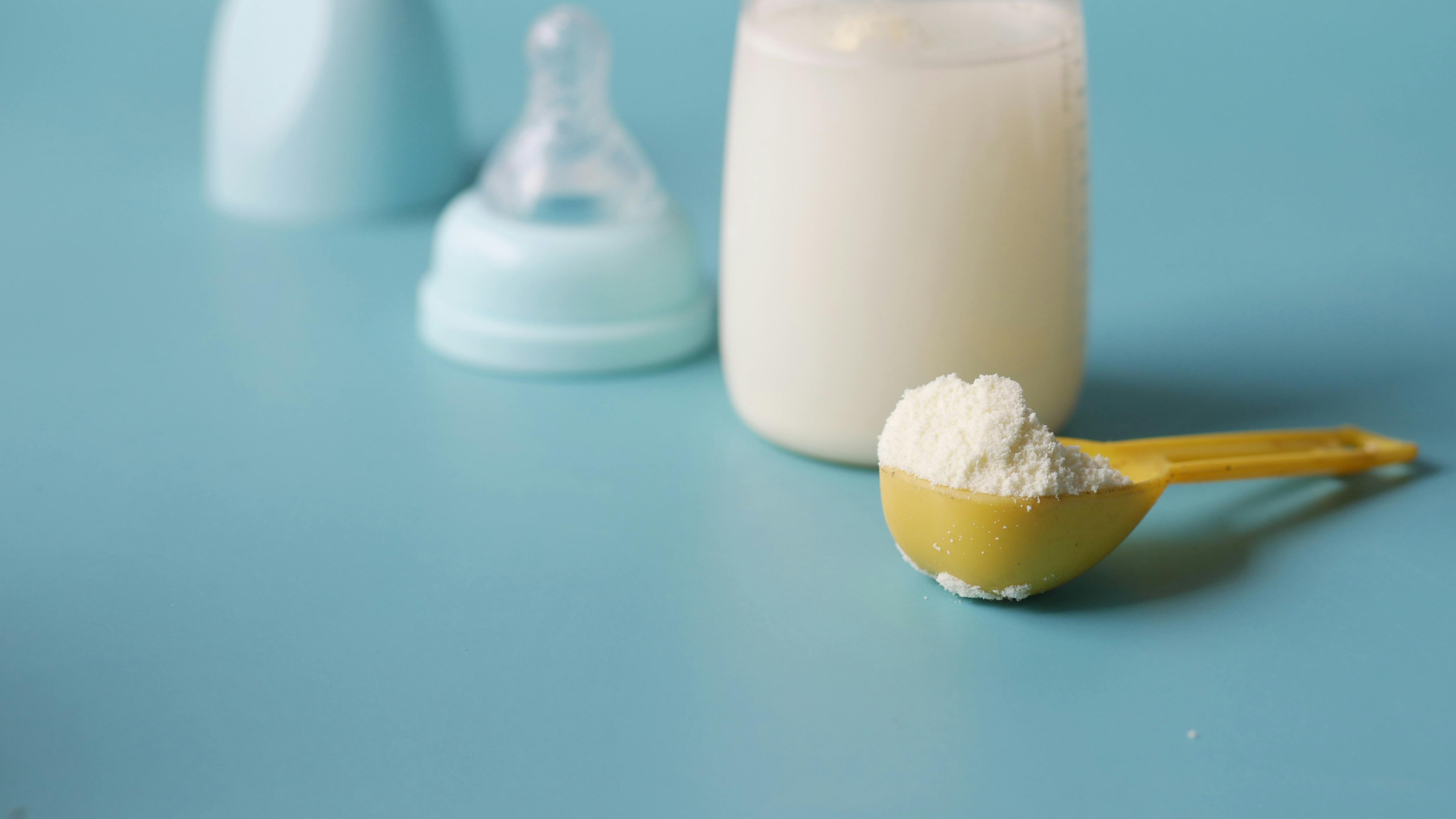 Various infant formula containers on a kitchen countertop to evaluate safety.