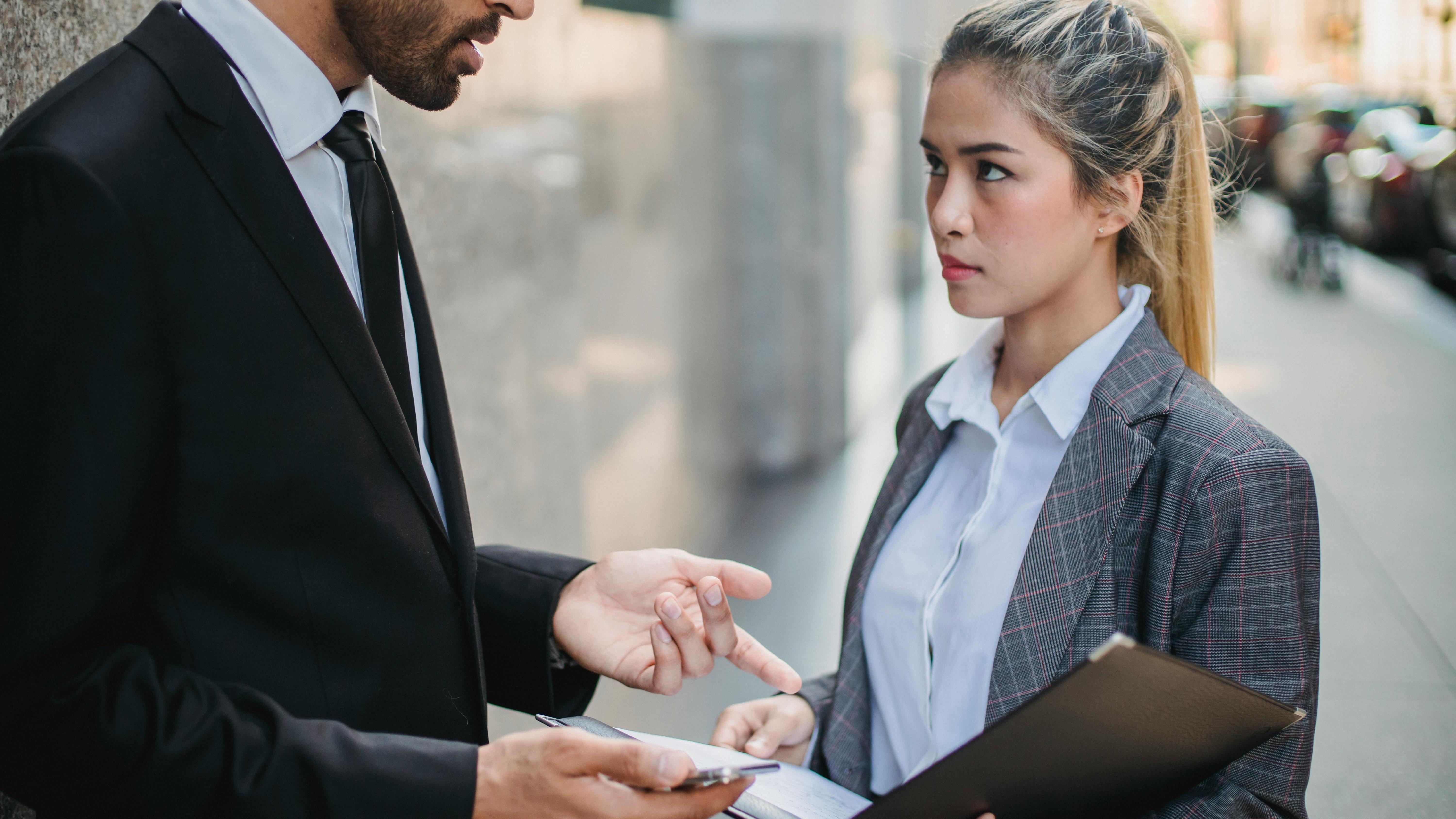 Surreal collage of statue heads in business attire for salary disparities workplace culture.