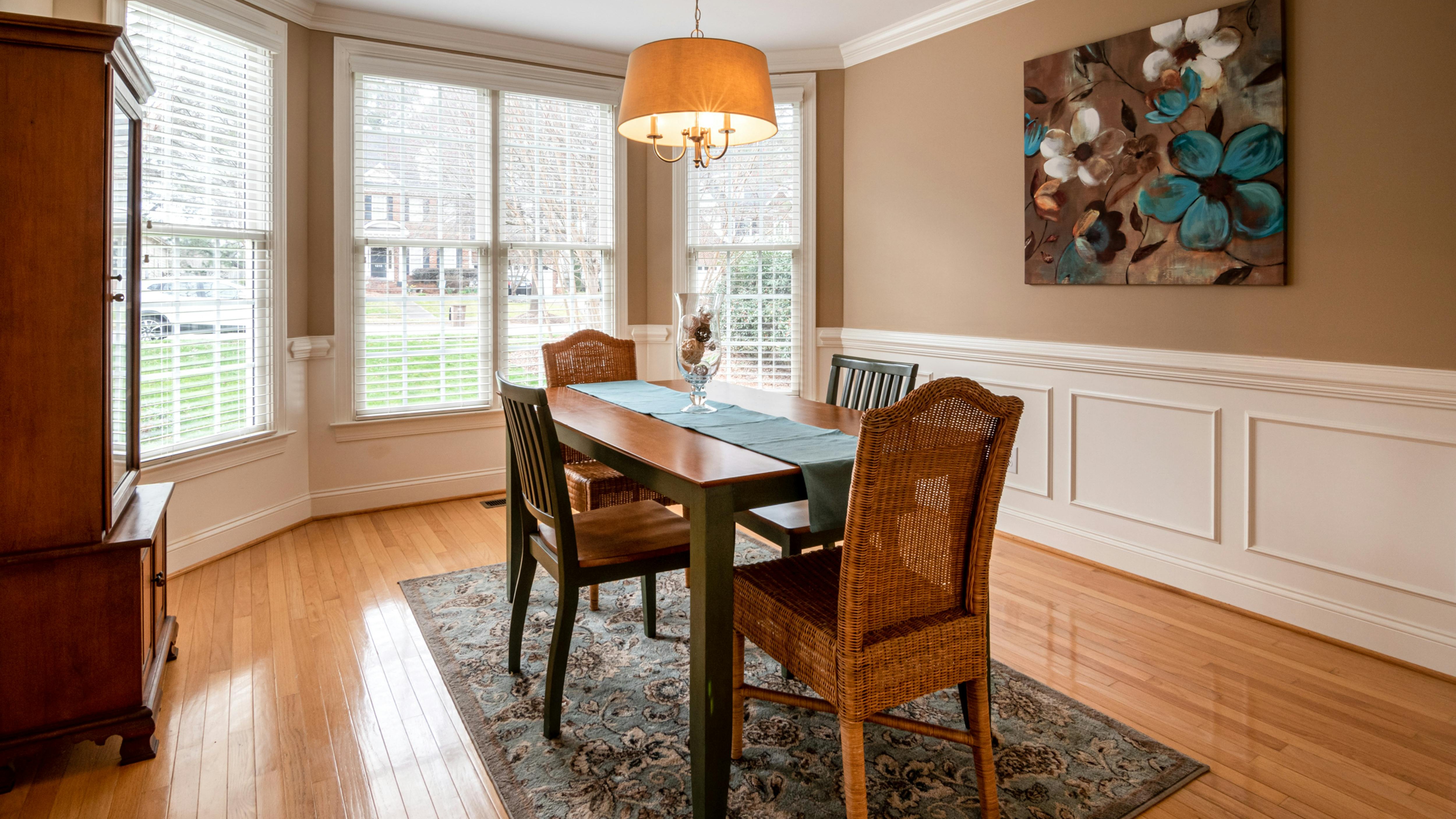 Retro dining room with vintage style and colorful art, depicting outdated dining room styles.