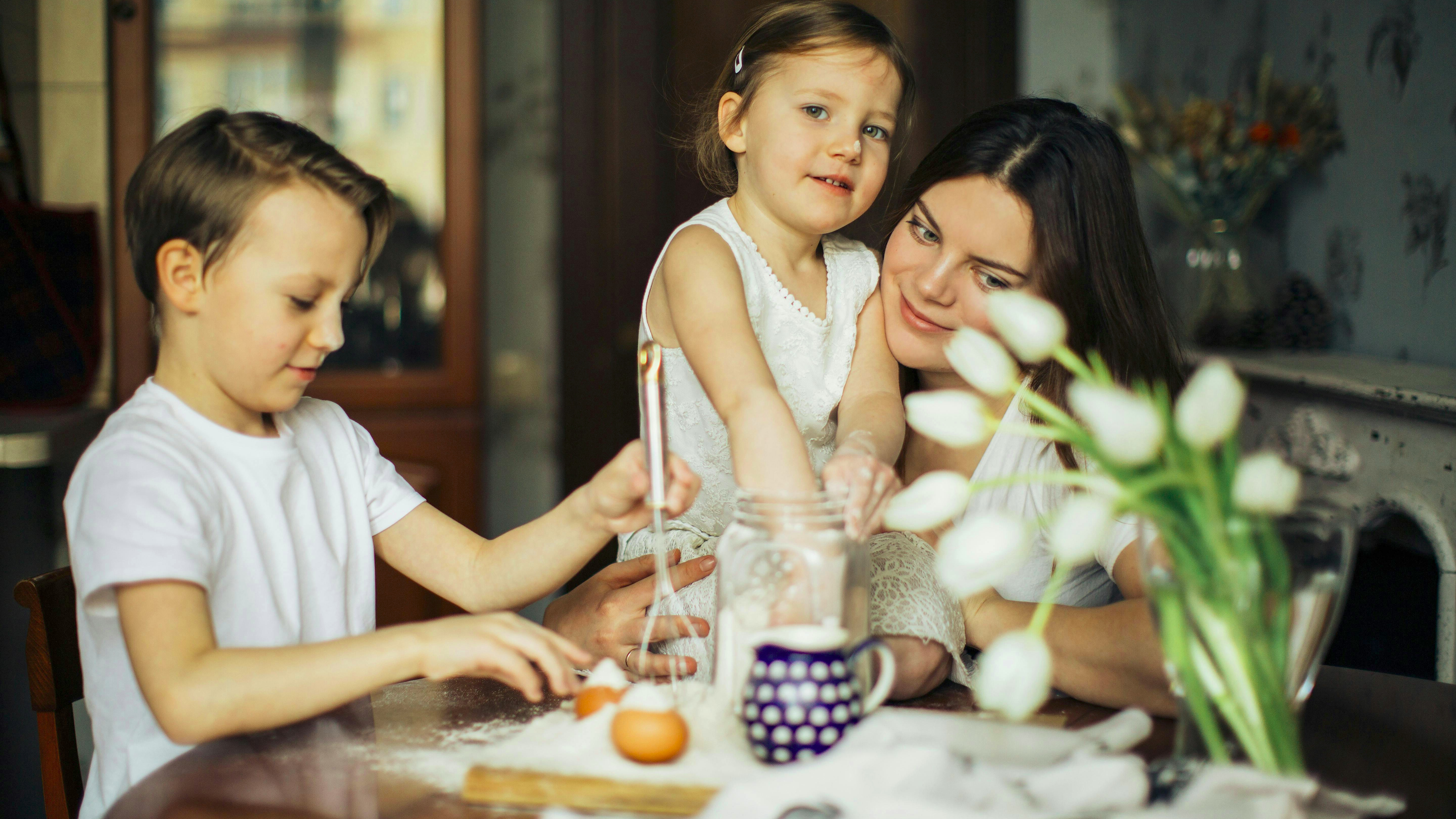 Cheerful mom and daughter with ice cream at an outdoor parlor, embodying the butter mom approach to food.