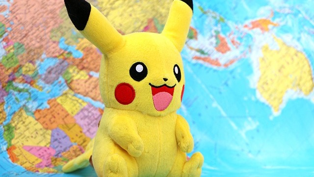 Vivid Pokémon competition scene in a colorful arena with cheering crowd.