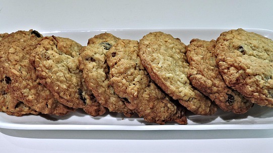 Freshly baked cranberry oatmeal cookies on a cooling rack.