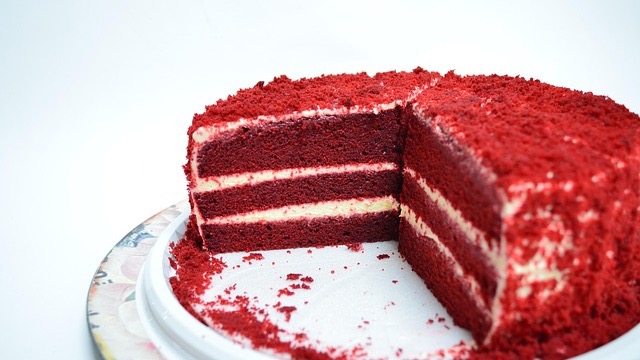 Red Velvet Cake Blizzard with cake chunks in a vibrant red setting.