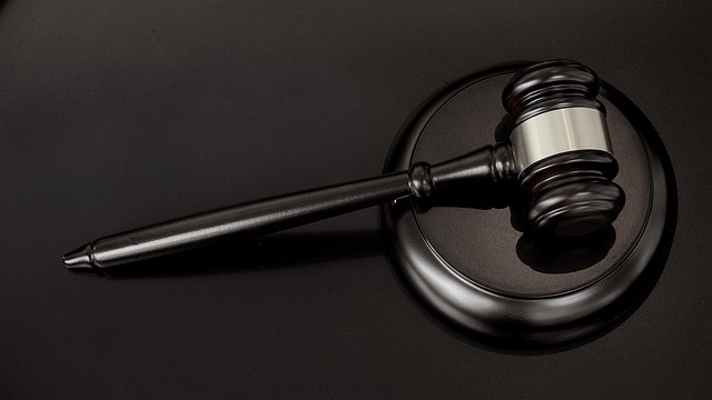 Corporate building entrance with Verizon logo in daylight.