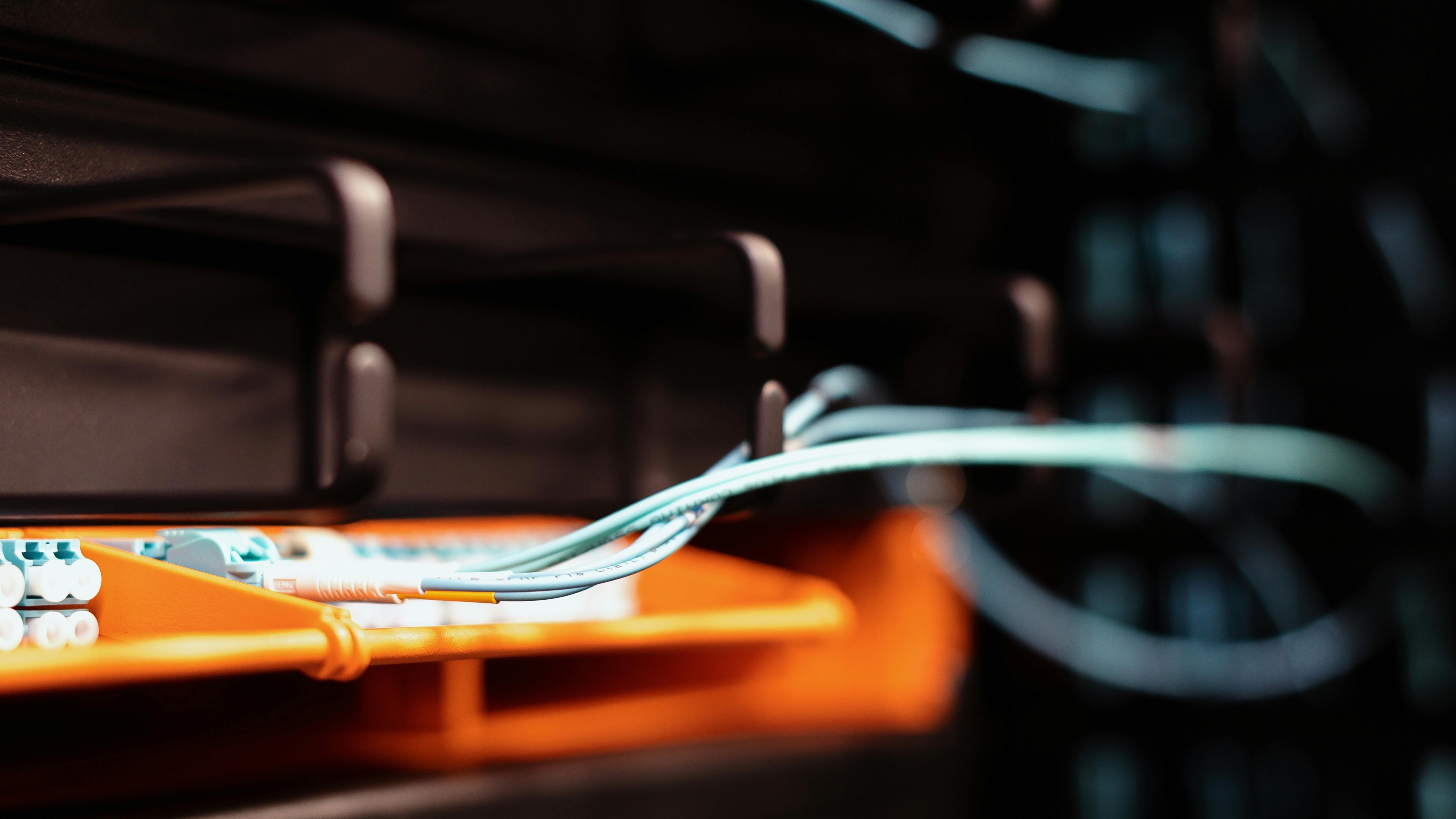 Vibrant display of symmetrical 10 Gbps fiber internet cables glowing.