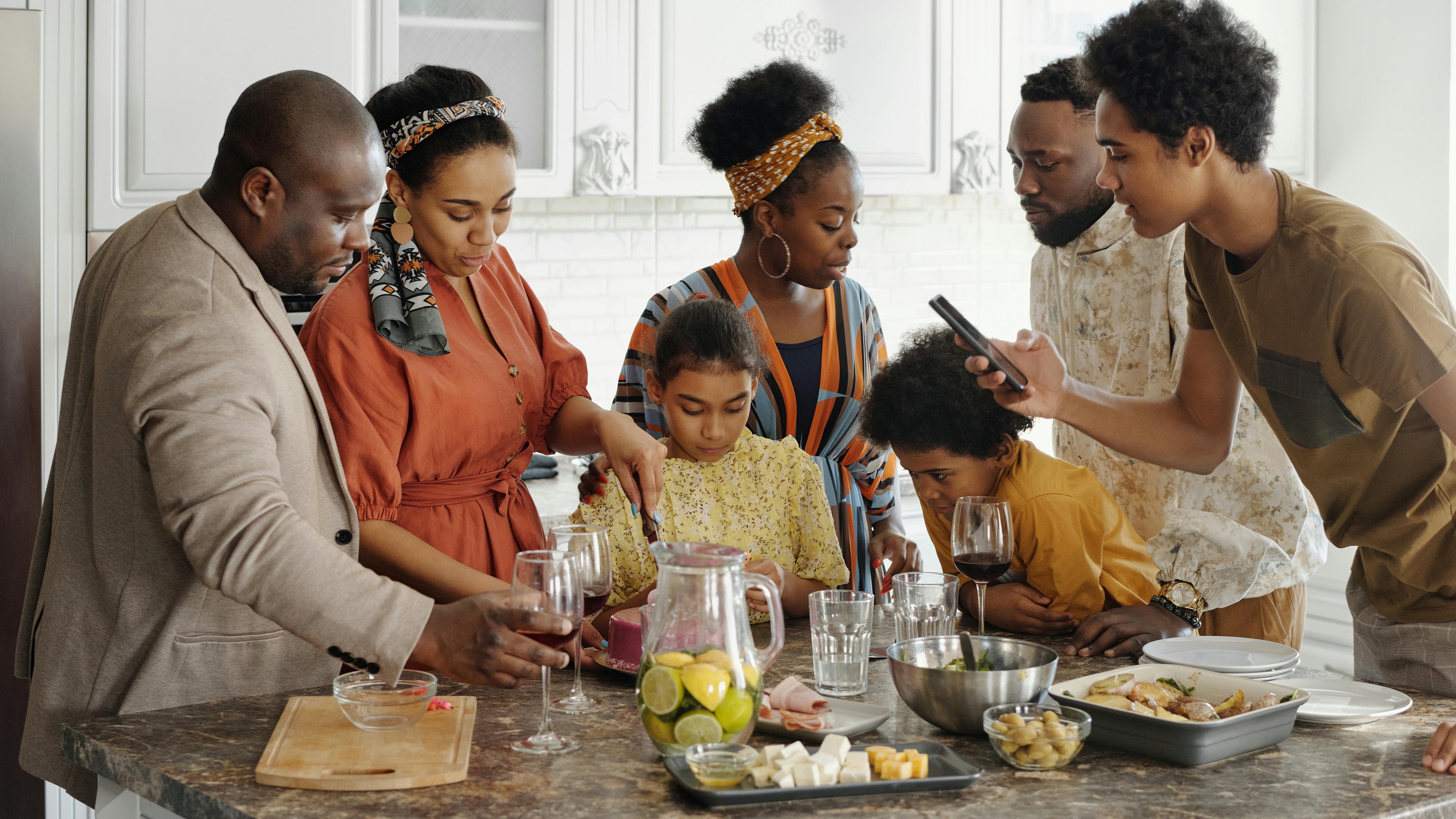 Multicultural Thanksgiving dinner with joyful family and autumn decor.