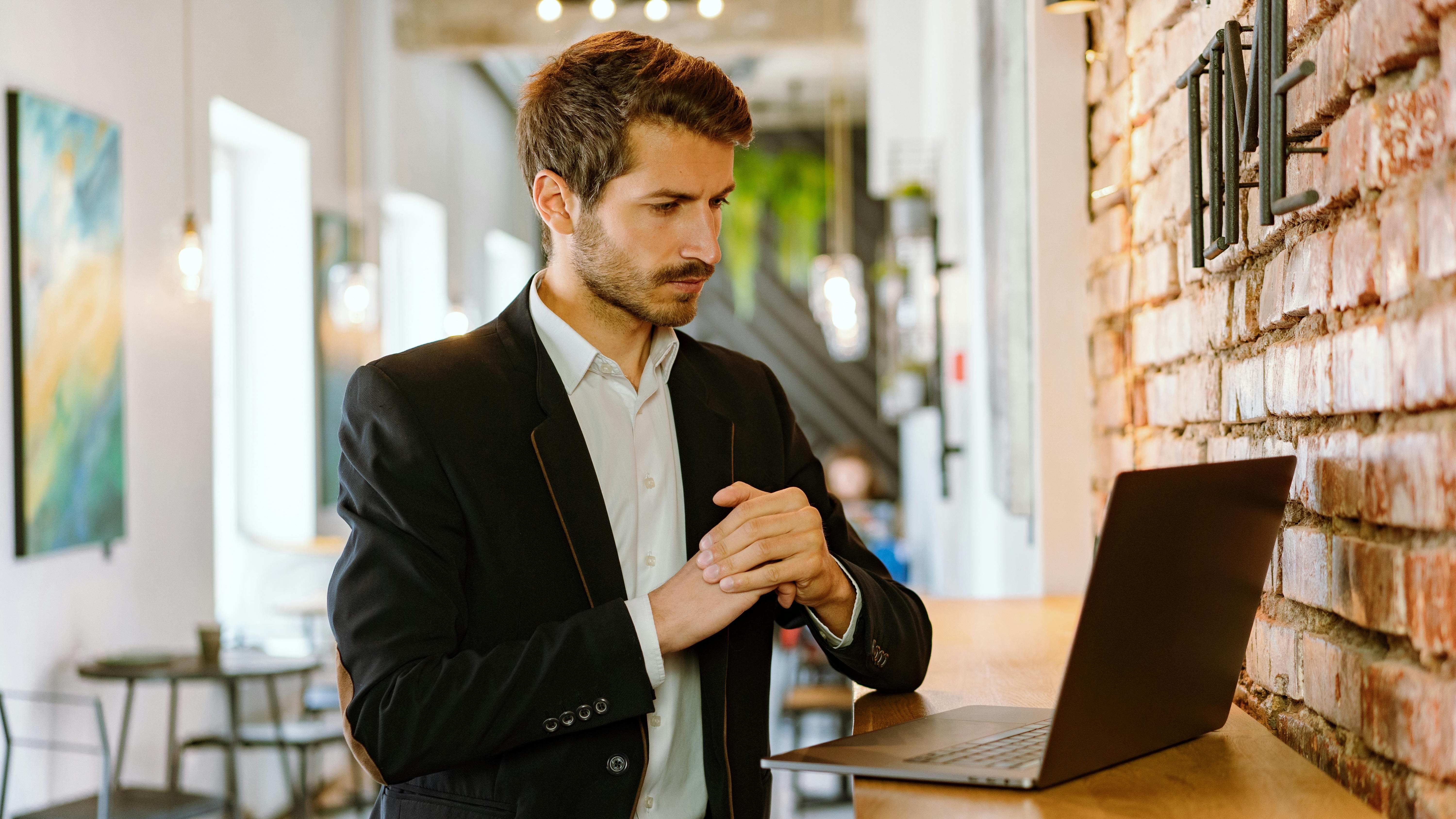Freelancers working in a cafe, focused on laptops, amid layoffs.