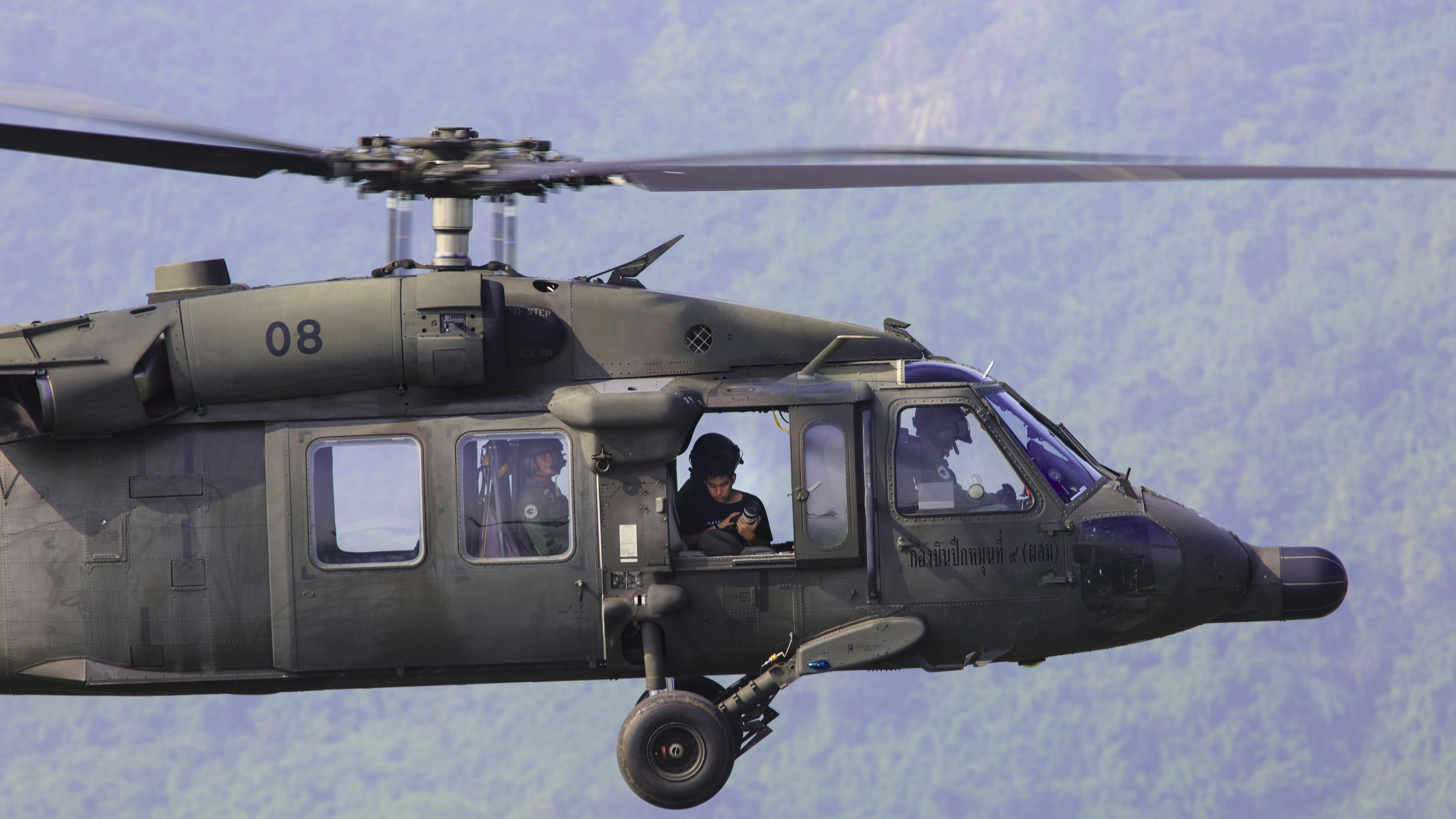 Autonomous unmanned Black Hawk helicopter on cracked tarmac.