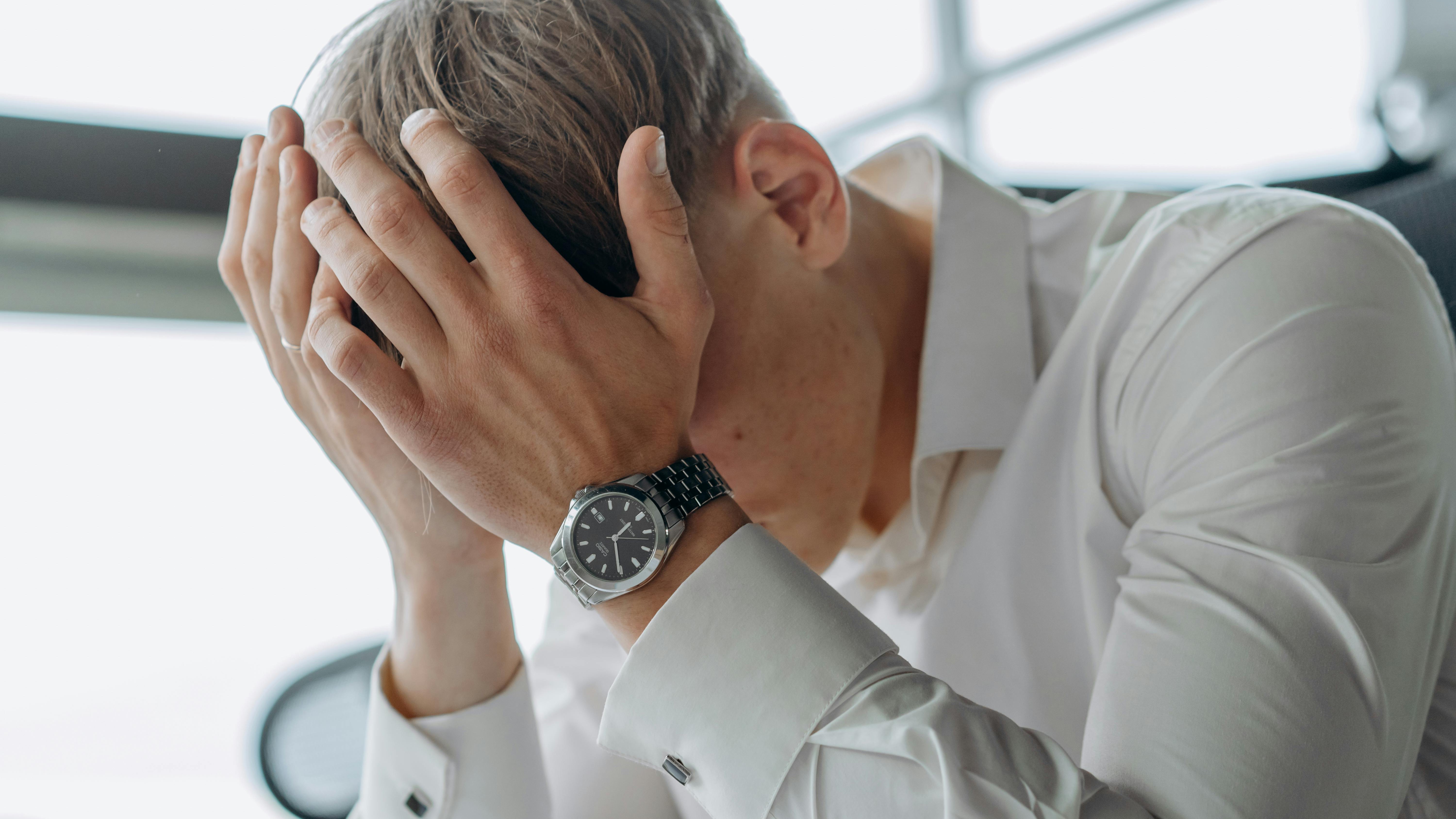 Stressed man in office at night surviving a bad job.
