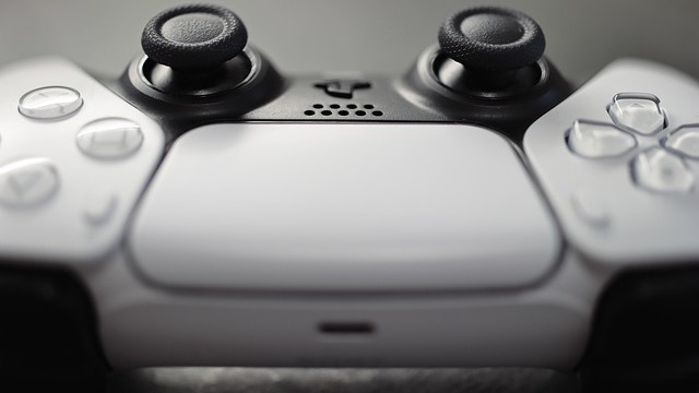Sleek PS5 Pro vs PS5 consoles comparison on blue background.
