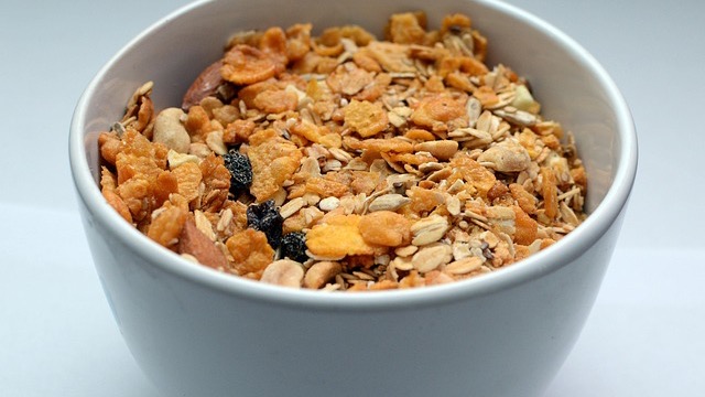 Stacked peanut butter granola bars on white surface.