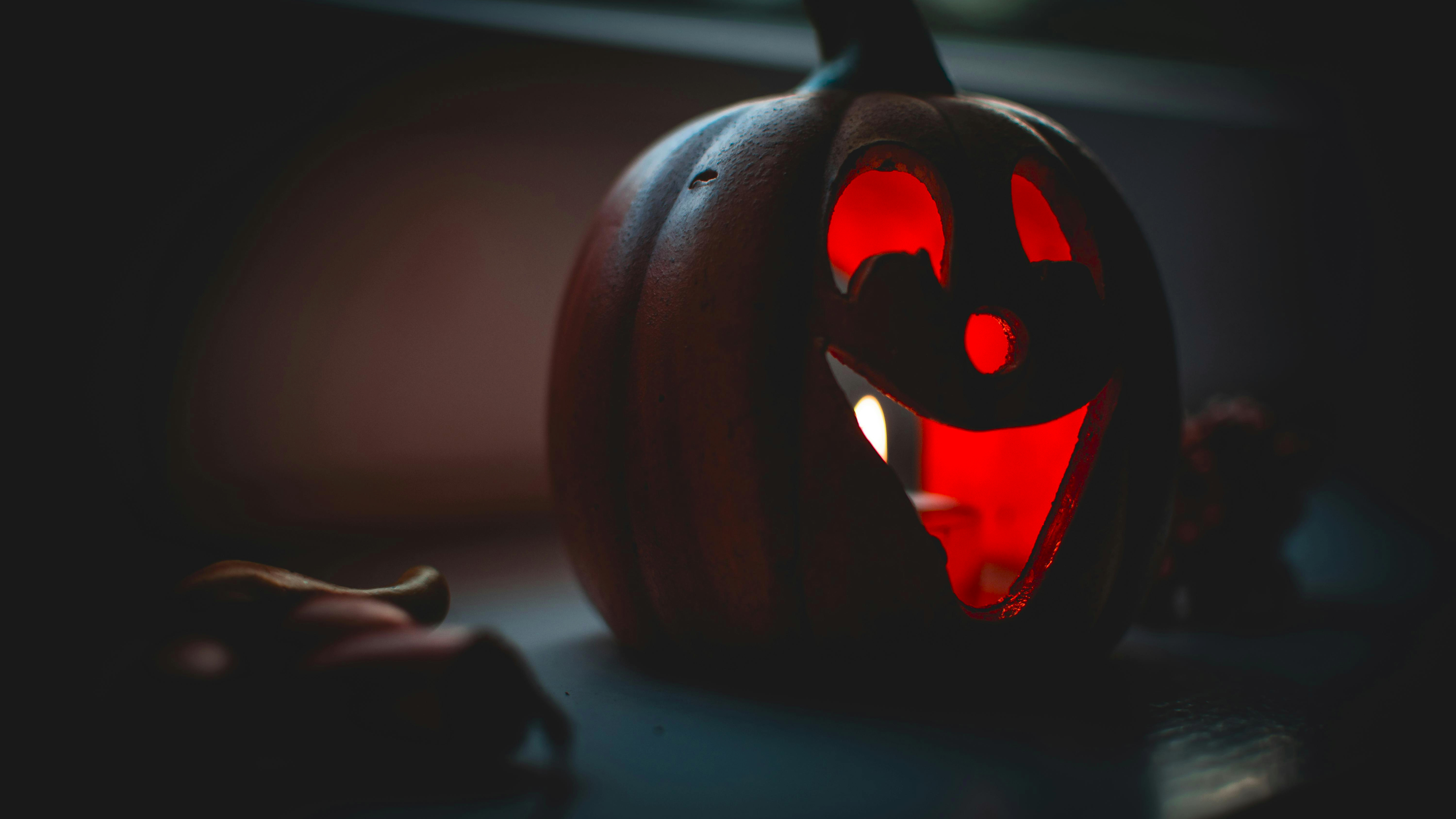 Unique hanging pumpkin planter with cascading ivy in natural light.